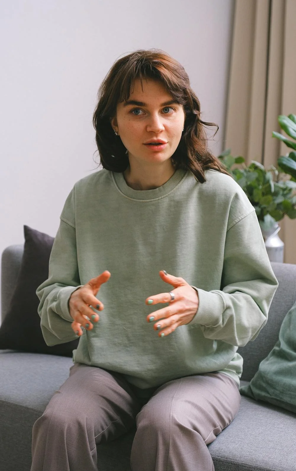 Young woman in her twenties looking anxious and talking animatedly