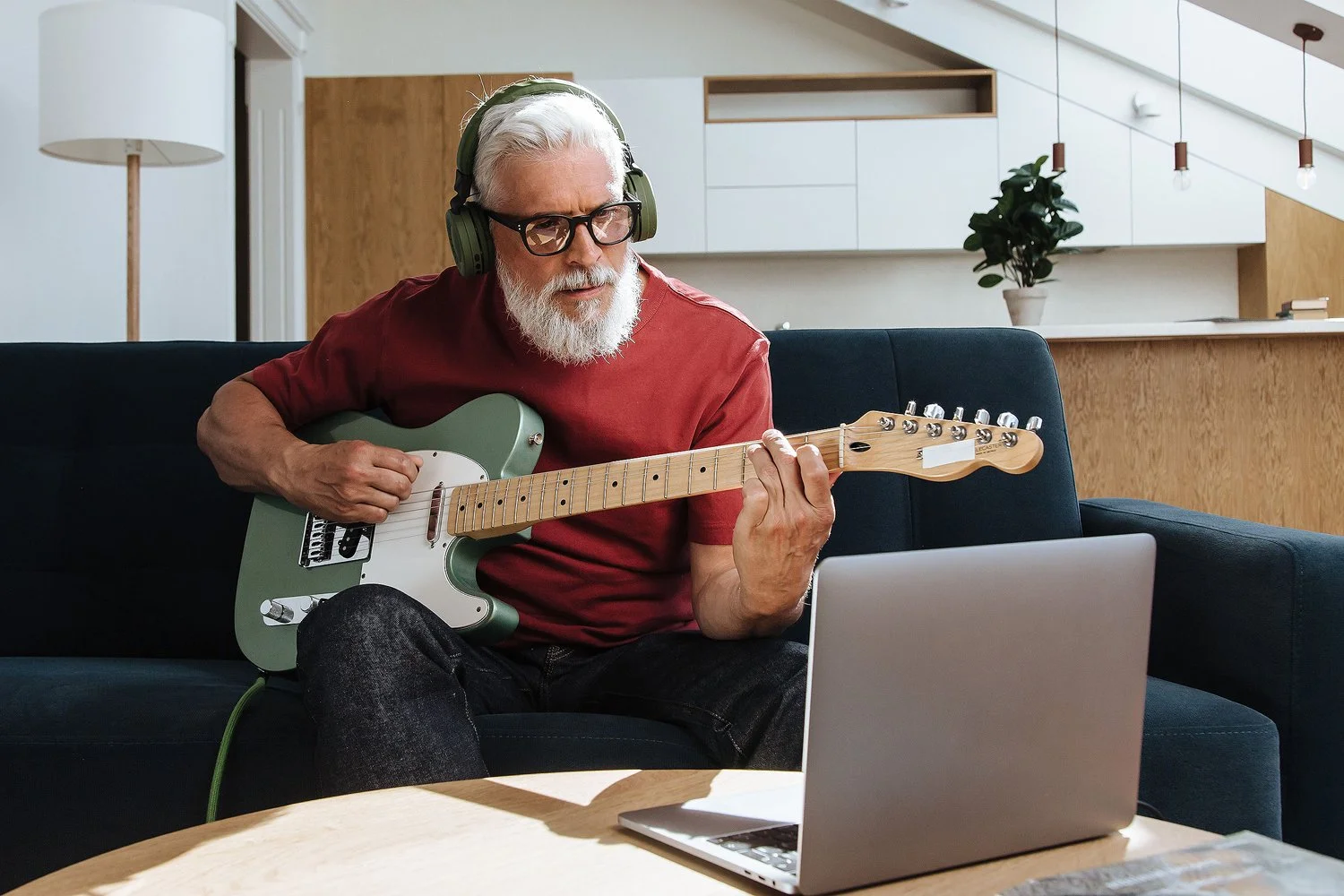 Guitar player using laptop
