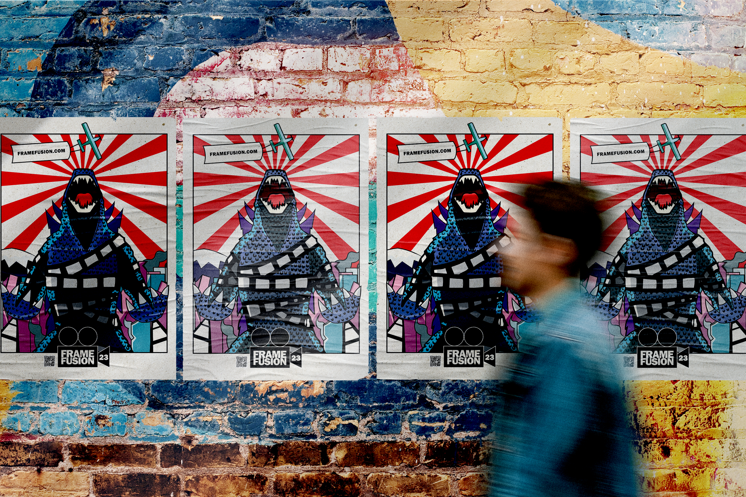 Four posters featuring a stylized dinosaur with a film strip wrapped around its neck, set against a background of red and white rays, are taped to a brick wall painted in multiple colors, with a blurred person walking past in front of the posters.