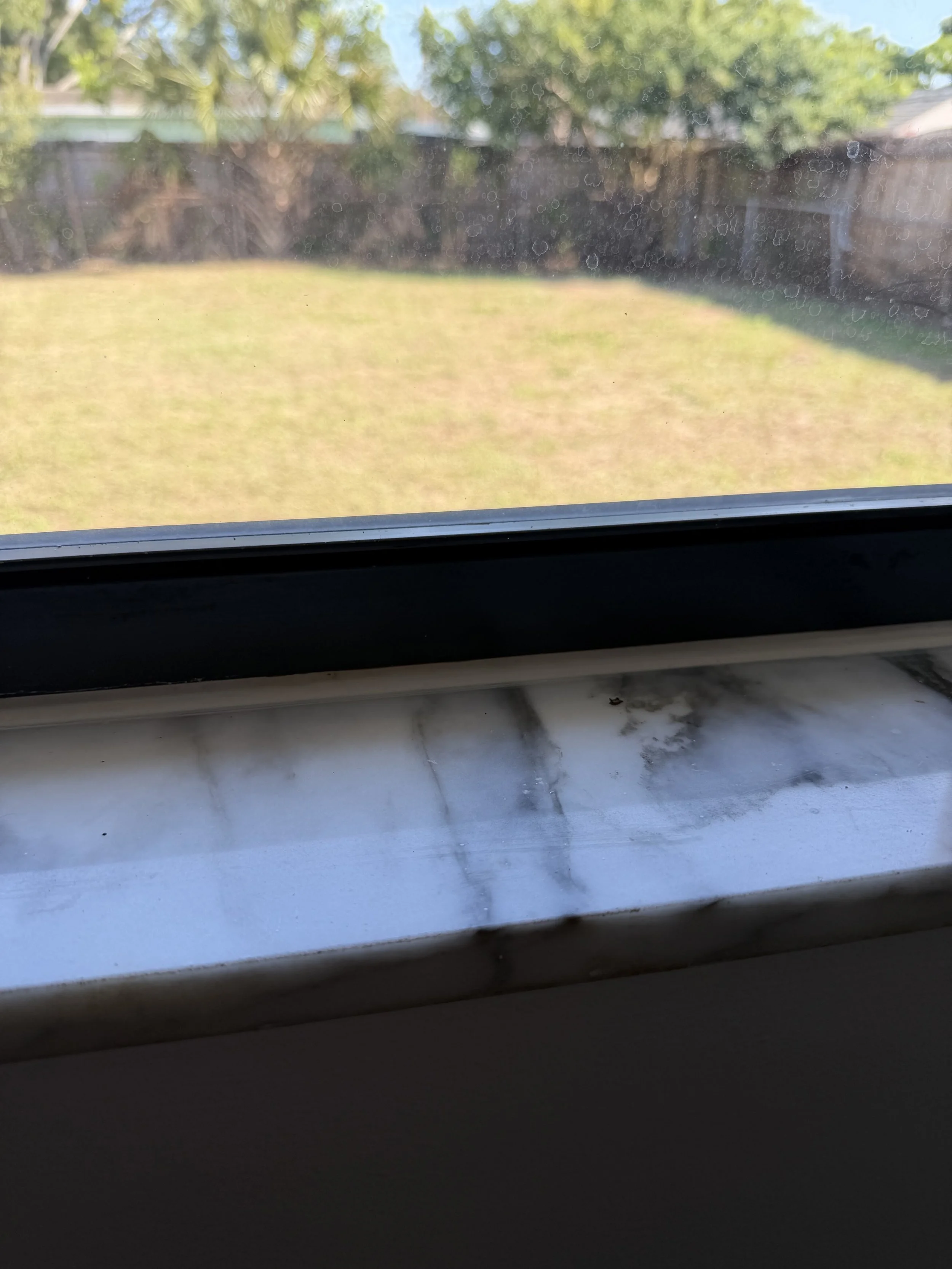 Close-up of the same windowsill from the prior photo with the caulk refreshed to a pristine white.