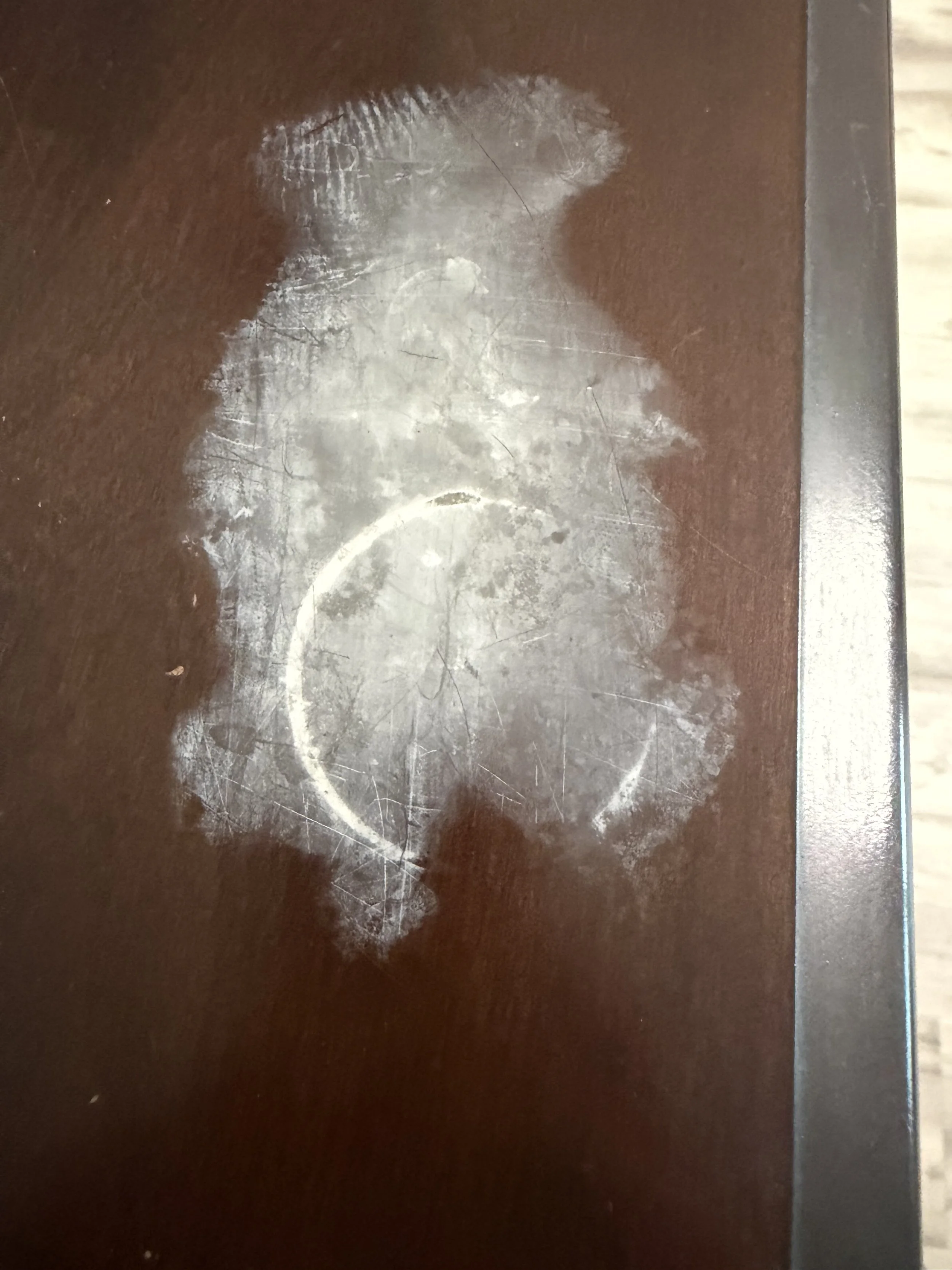 Scratched and worn surface with a visible chalk or paint outline of a number 8.