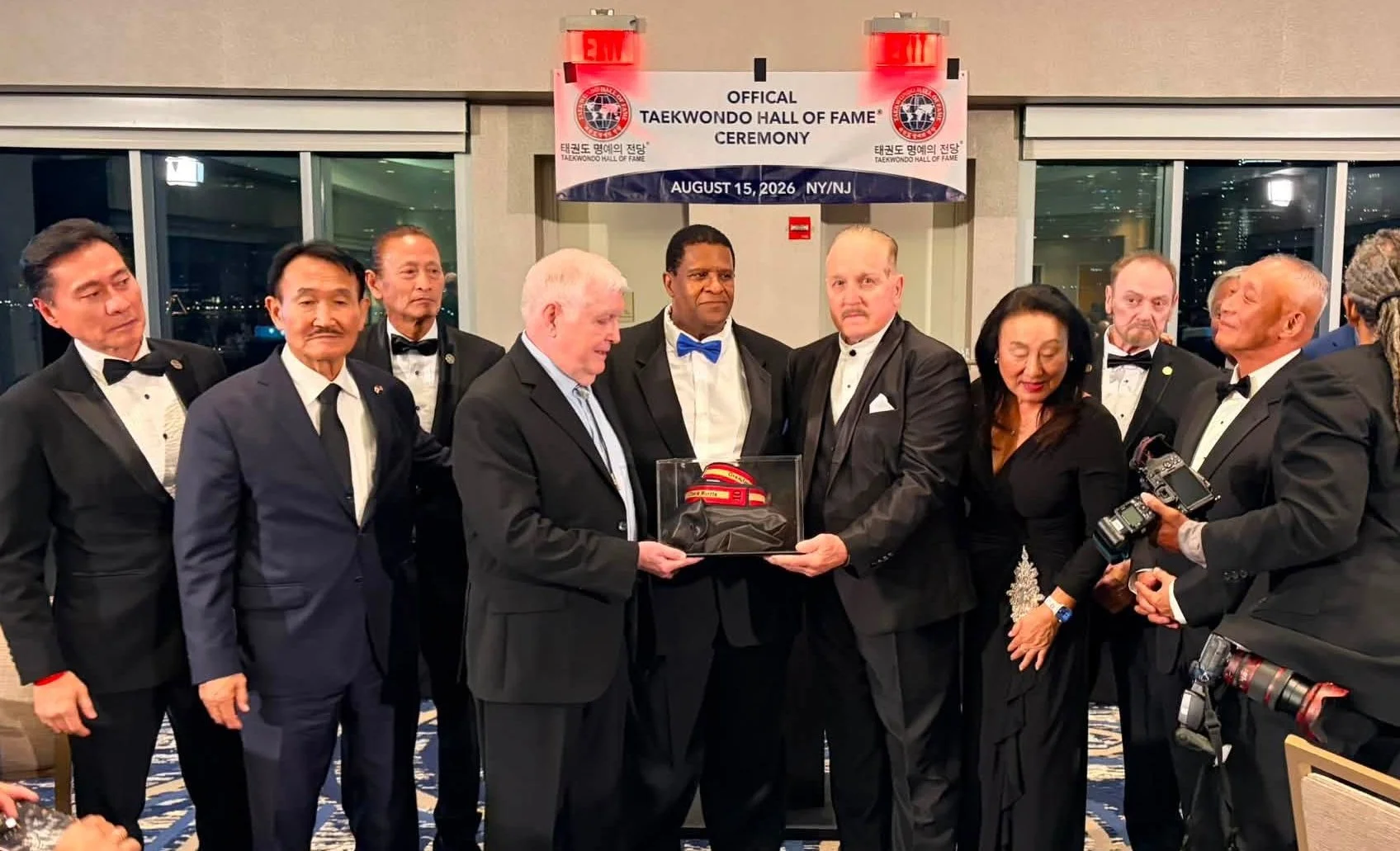 Keith Yates presents the Chuck Norris belt to the Taekwondo Hall of Fame.