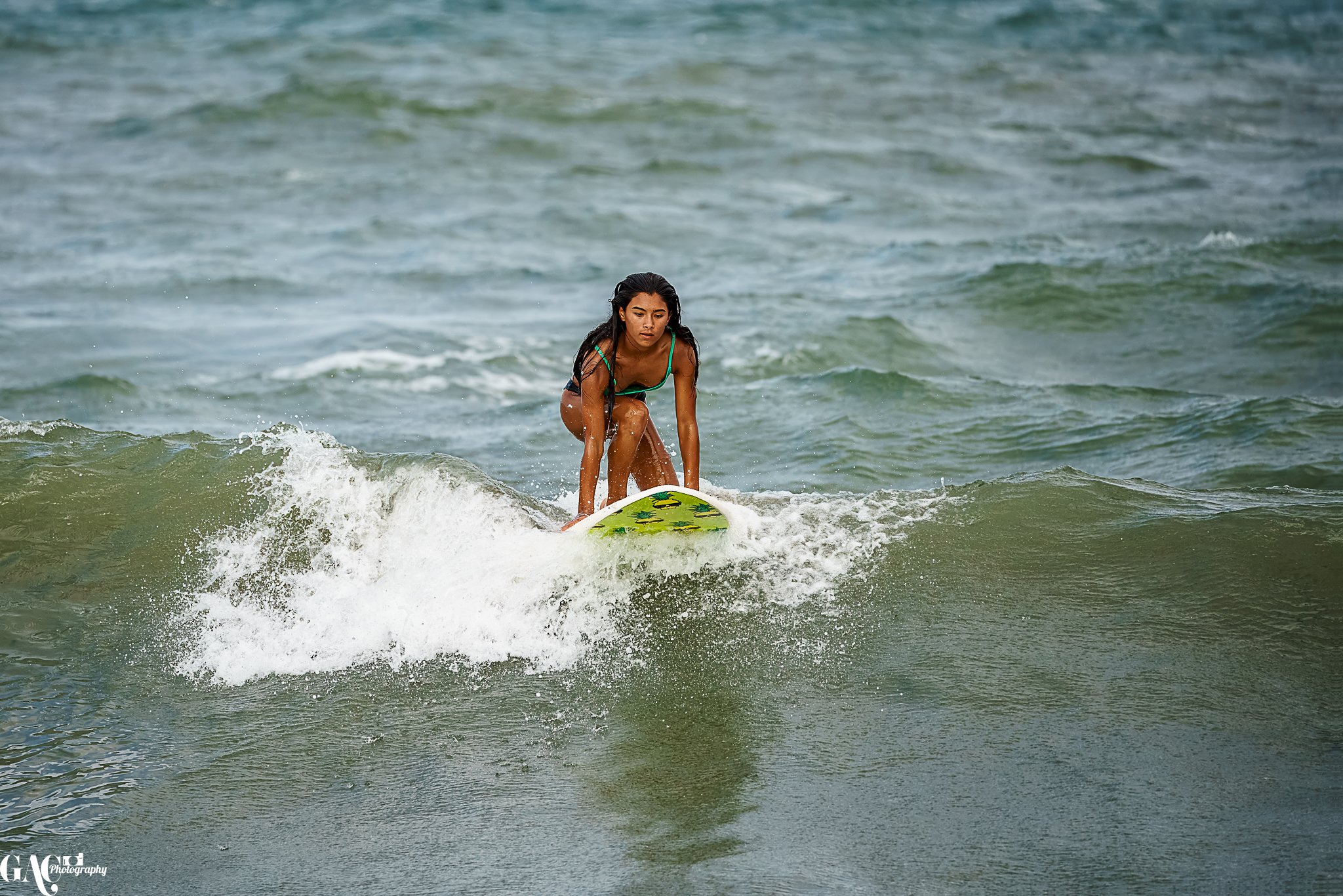 Woman surfing on a small wave in the ocean