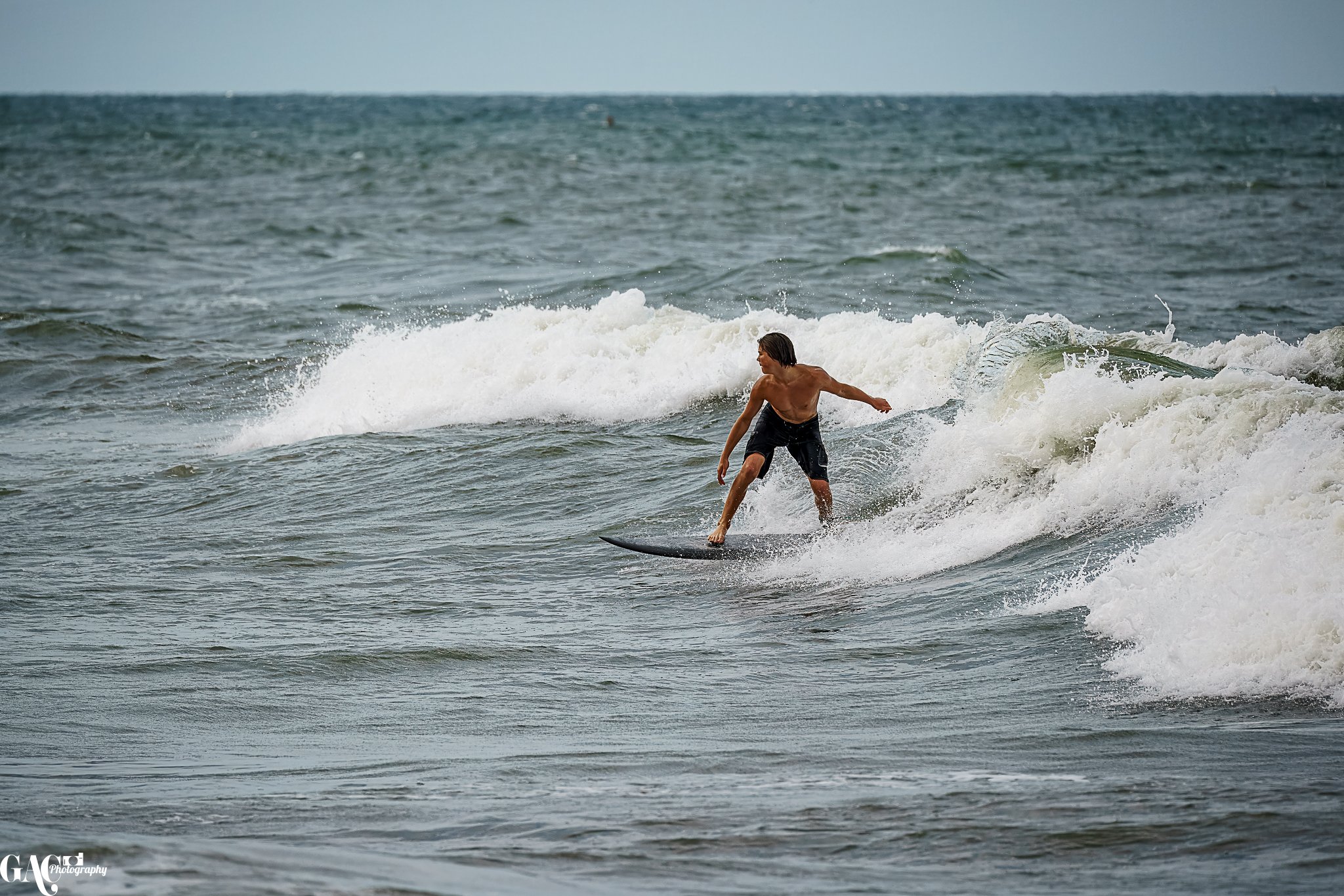 A person surfing on a wave in the ocean.