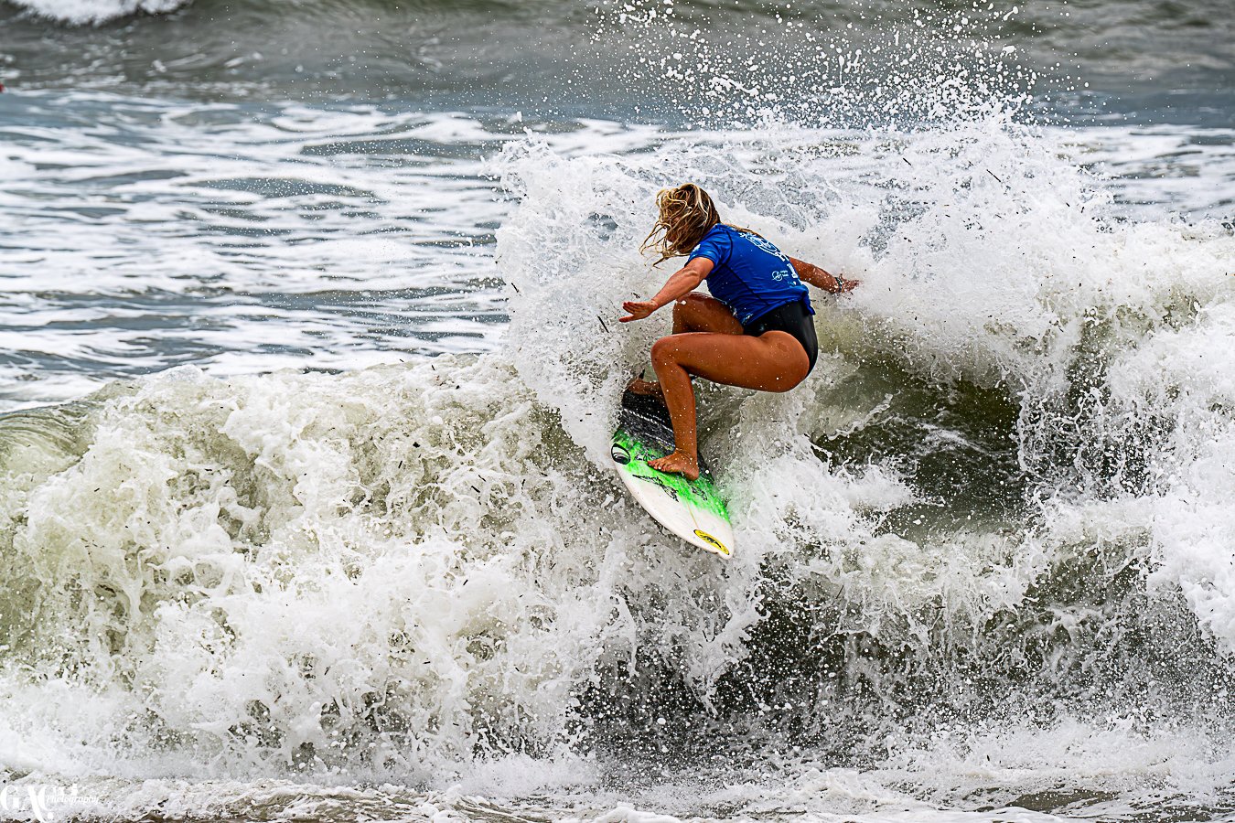 A person surfing on a surfboard in the ocean during the daytime.
