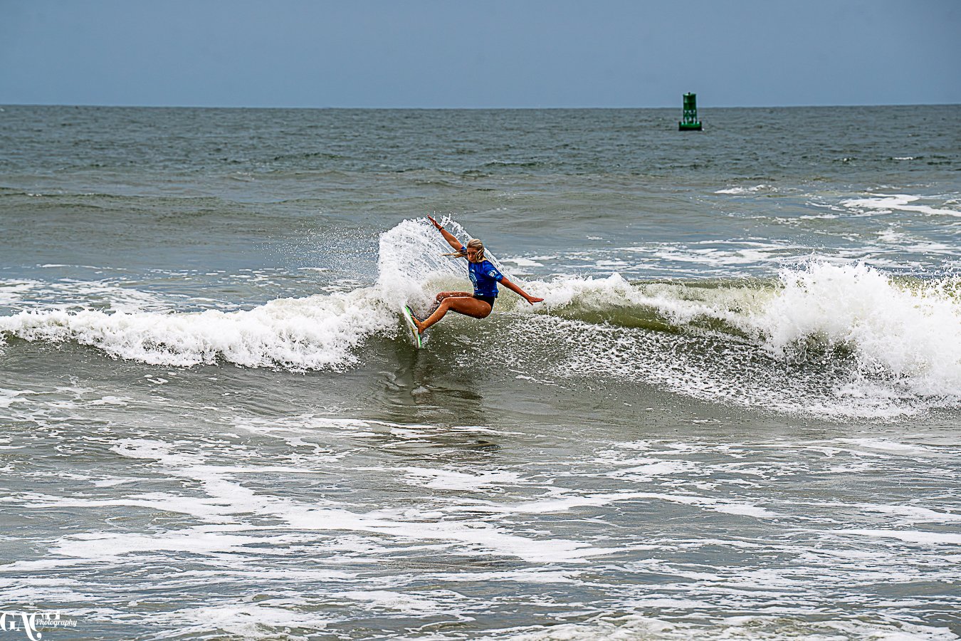 A person kiteboarding on the ocean waves during daytime.