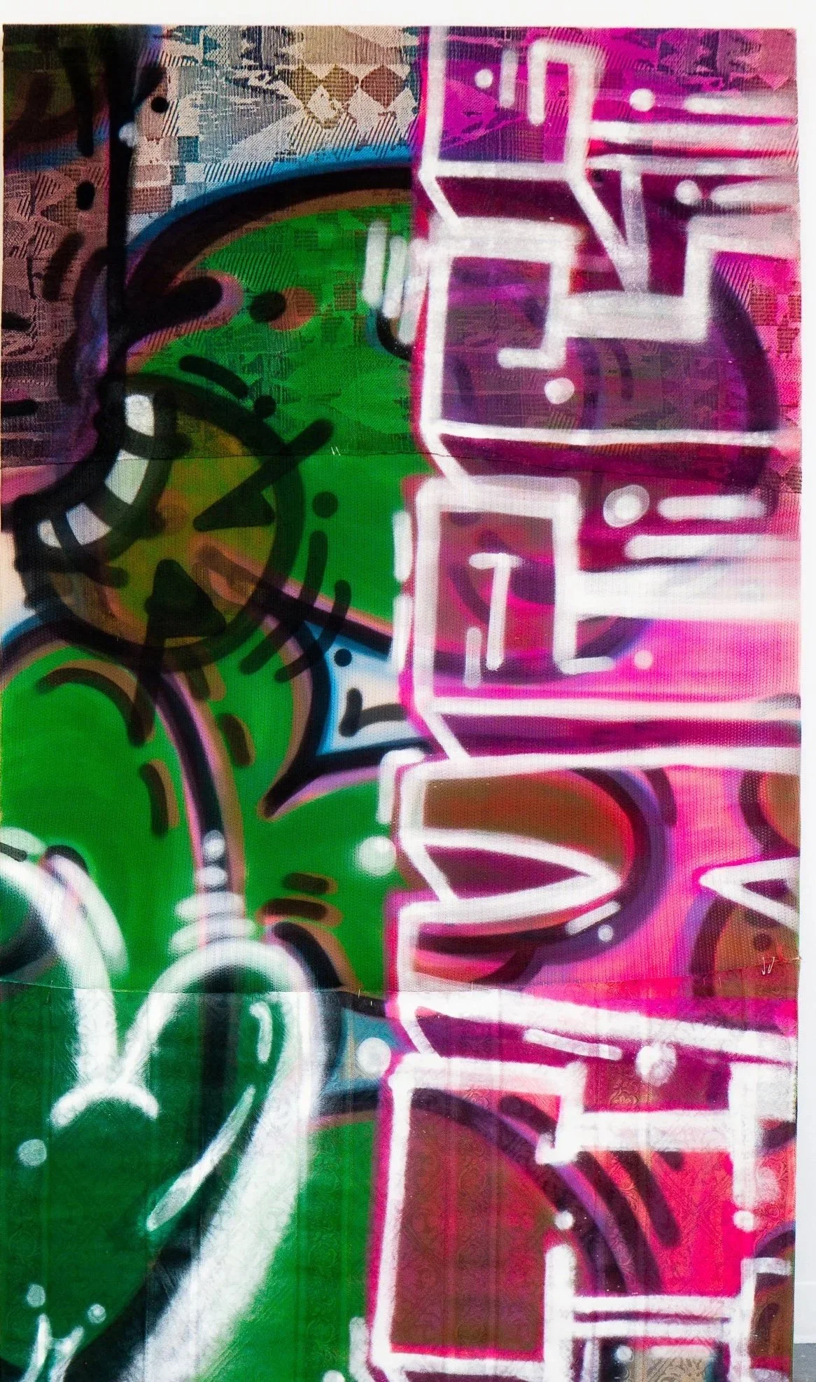 Colorful graffiti with abstract shapes and neon pink and green highlights.