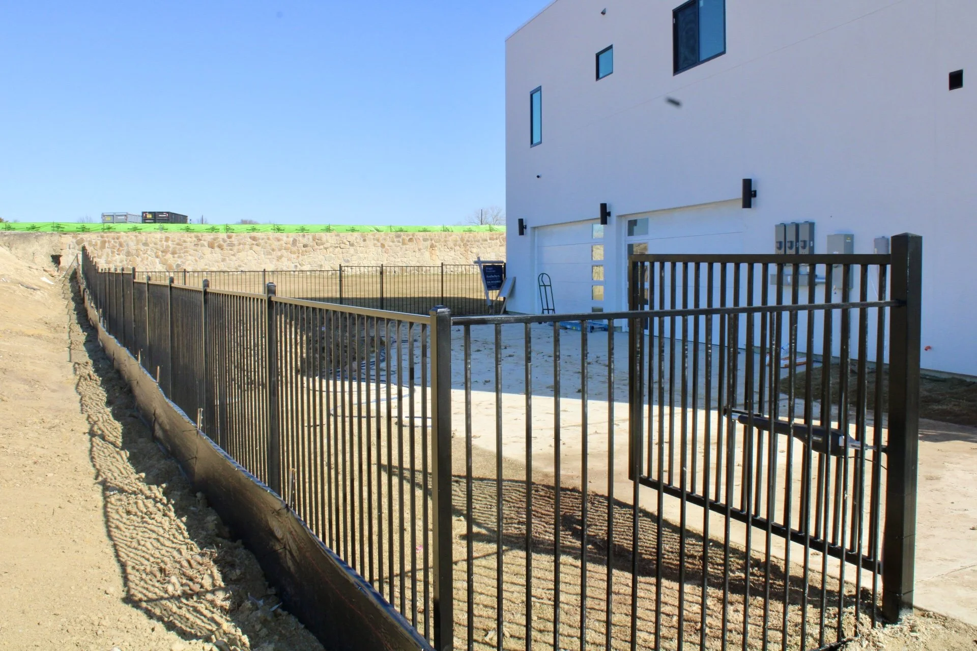 Residential metal fence and gate installation by Spillers Metal Buildings.