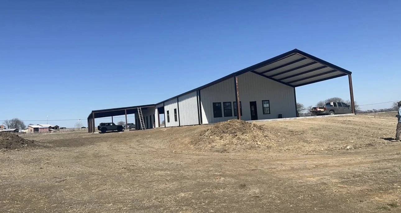 Custom barndominium with attached metal carport built in Texas.