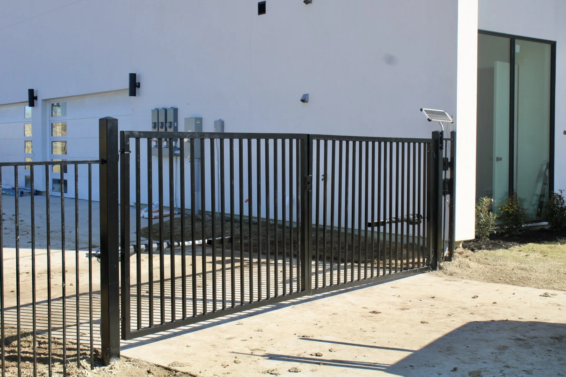 Residential metal fence and gate installation by Spillers Metal Buildings.