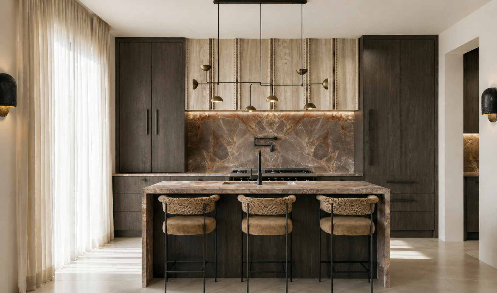 Modern kitchen with dark wood cabinets, marble backsplash, marble island with three chairs, a black faucet, and pendant lighting fixtures.