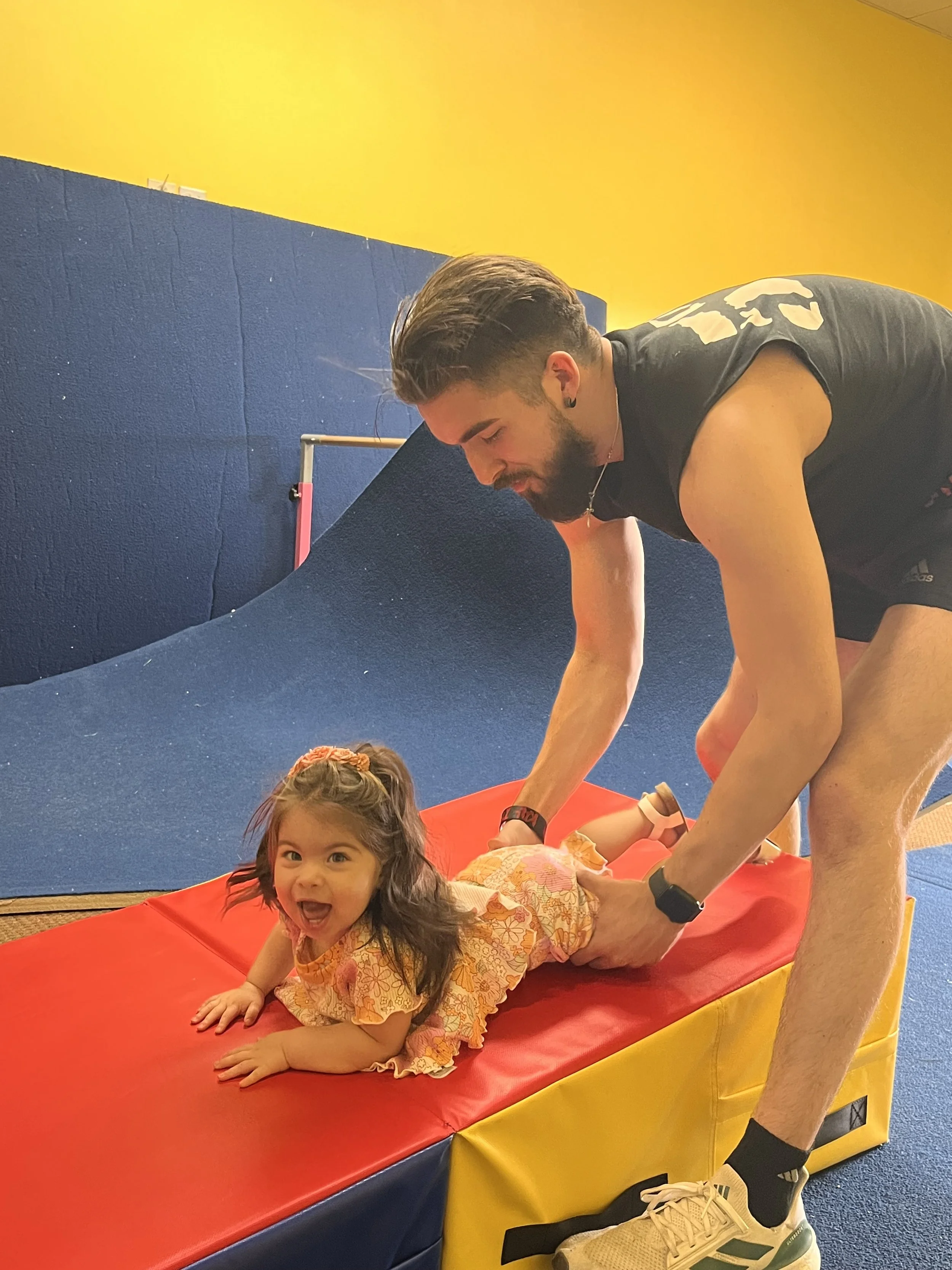 Mariana and her Dad trying out the gymnastics equipment!