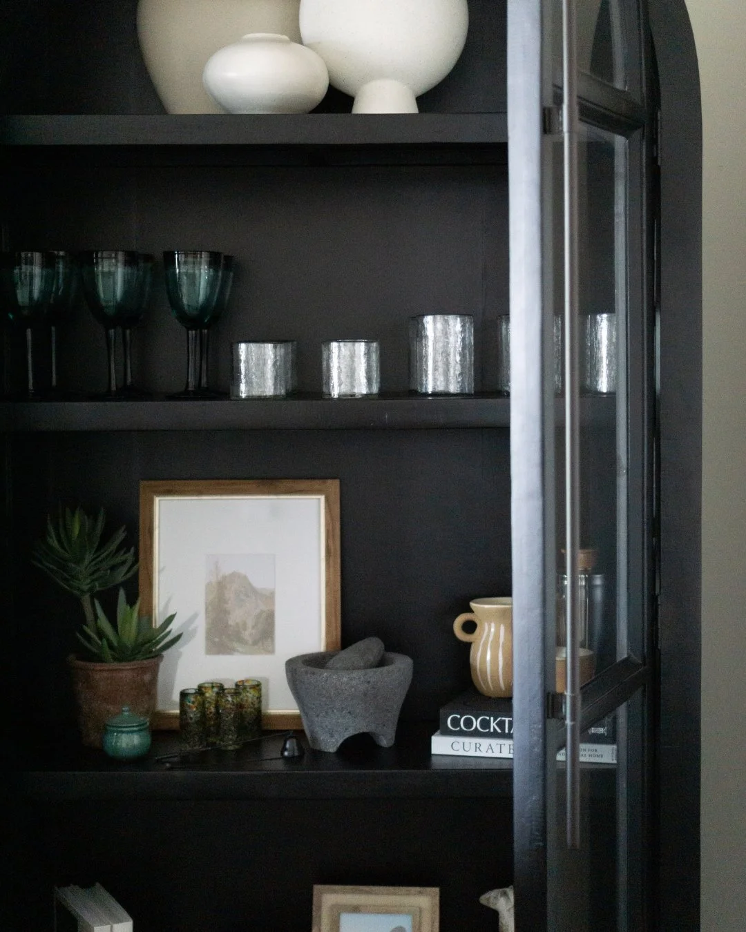 Behind the styling ✨

Our clients purchased this beautiful arched cabinet for their vacation home, but weren't quite sure how to style or use the space inside. They wanted it to feel desert-inspired with touches of their Mexican heritage &mdash; whil