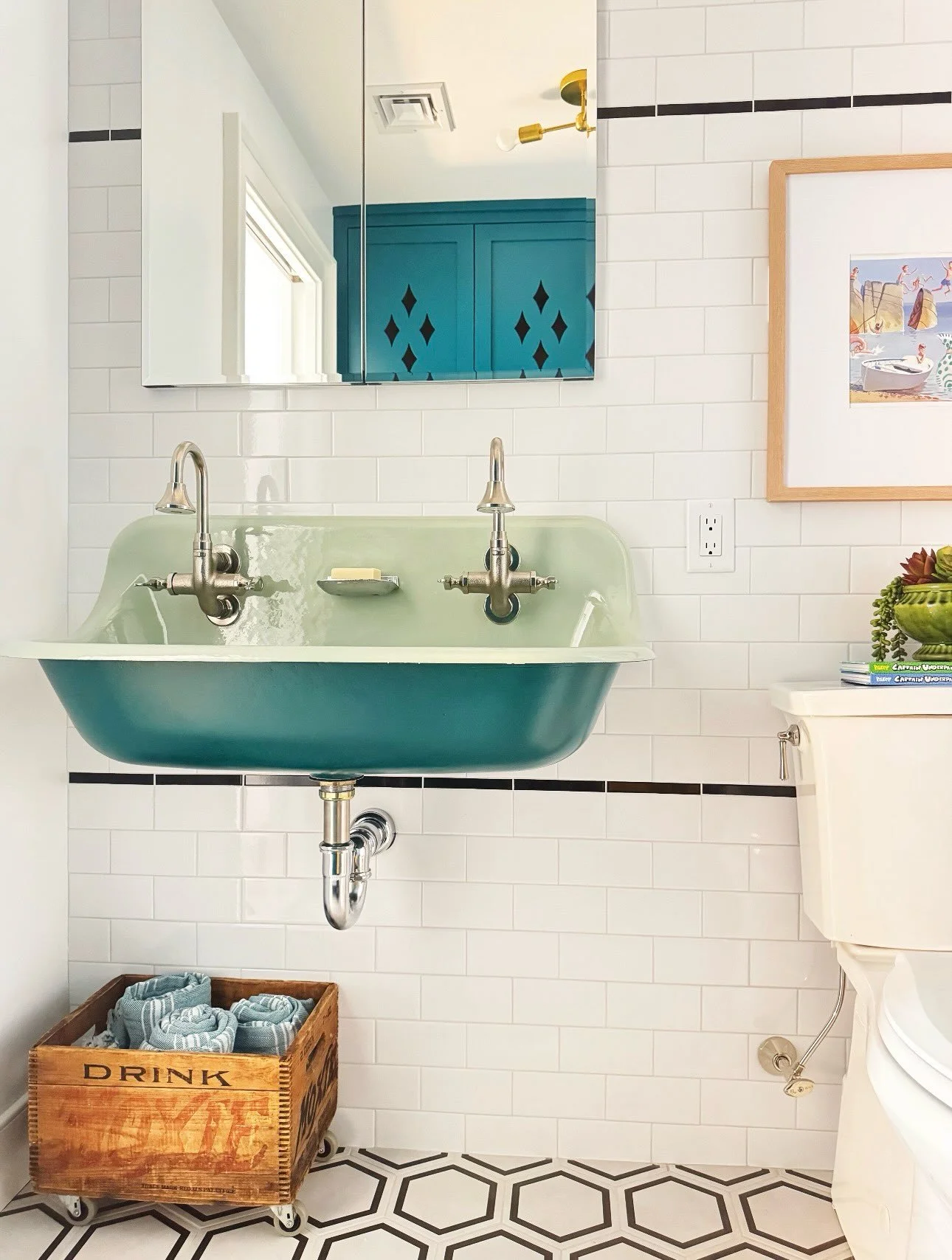 A bathroom for two teenage boys without designing a &ldquo;teenage boy bathroom.&rdquo;

This space needed to be practical and durable, but I still wanted it to have personality.

We started with the vintage style green sink and paired it with deep t