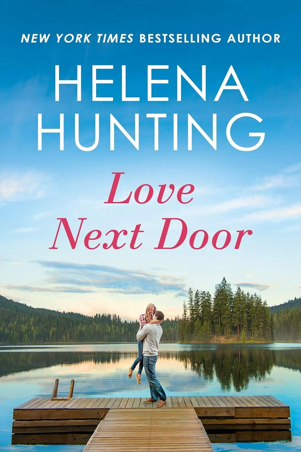 A man and woman standing on a wooden dock by a lake, with trees and mountains in the background, under a partly cloudy sky. Book Cover for "Love Next Door" by Helena Hunting