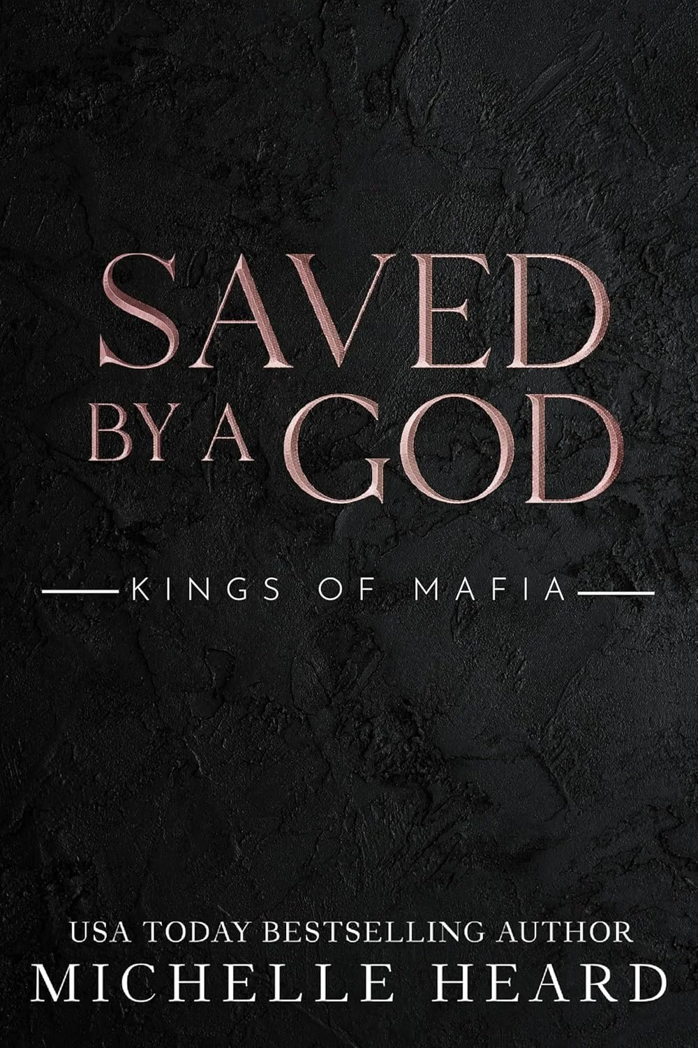 Book cover with black textured background and pink and white text that reads, 'Saved by a God - Kings of Mafia - USA Today Bestselling Author Michelle Heard'.