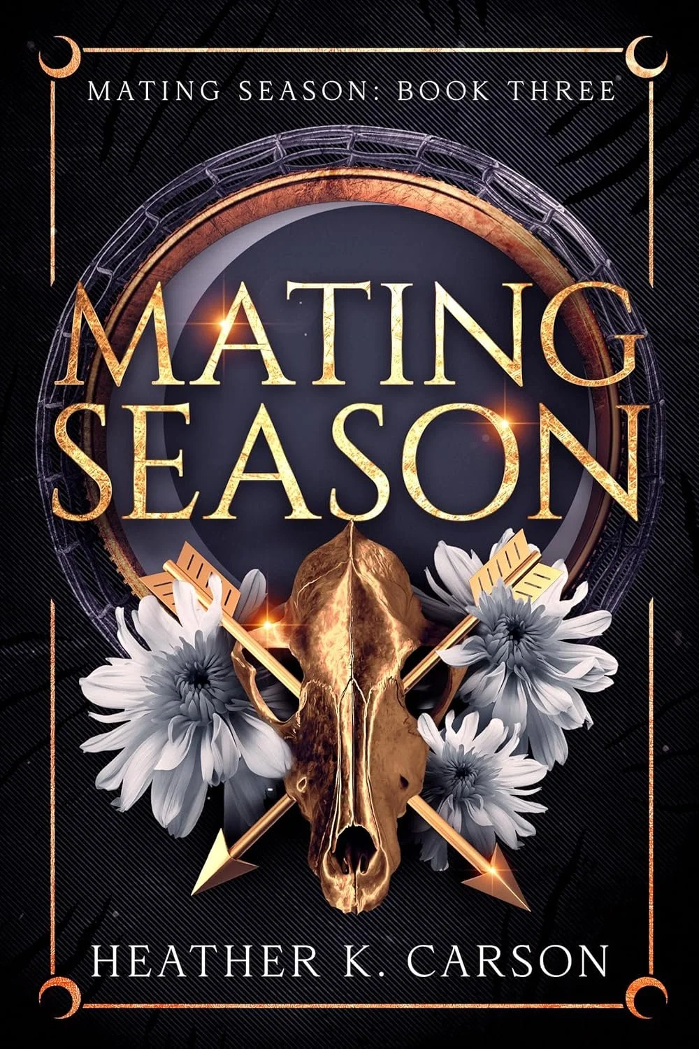 Book cover titled 'Mating Season: Book Three' by Heather K. Carson, featuring a gold-colored animal skull, white flowers, and decorative arrows against a dark background with geometric patterns.