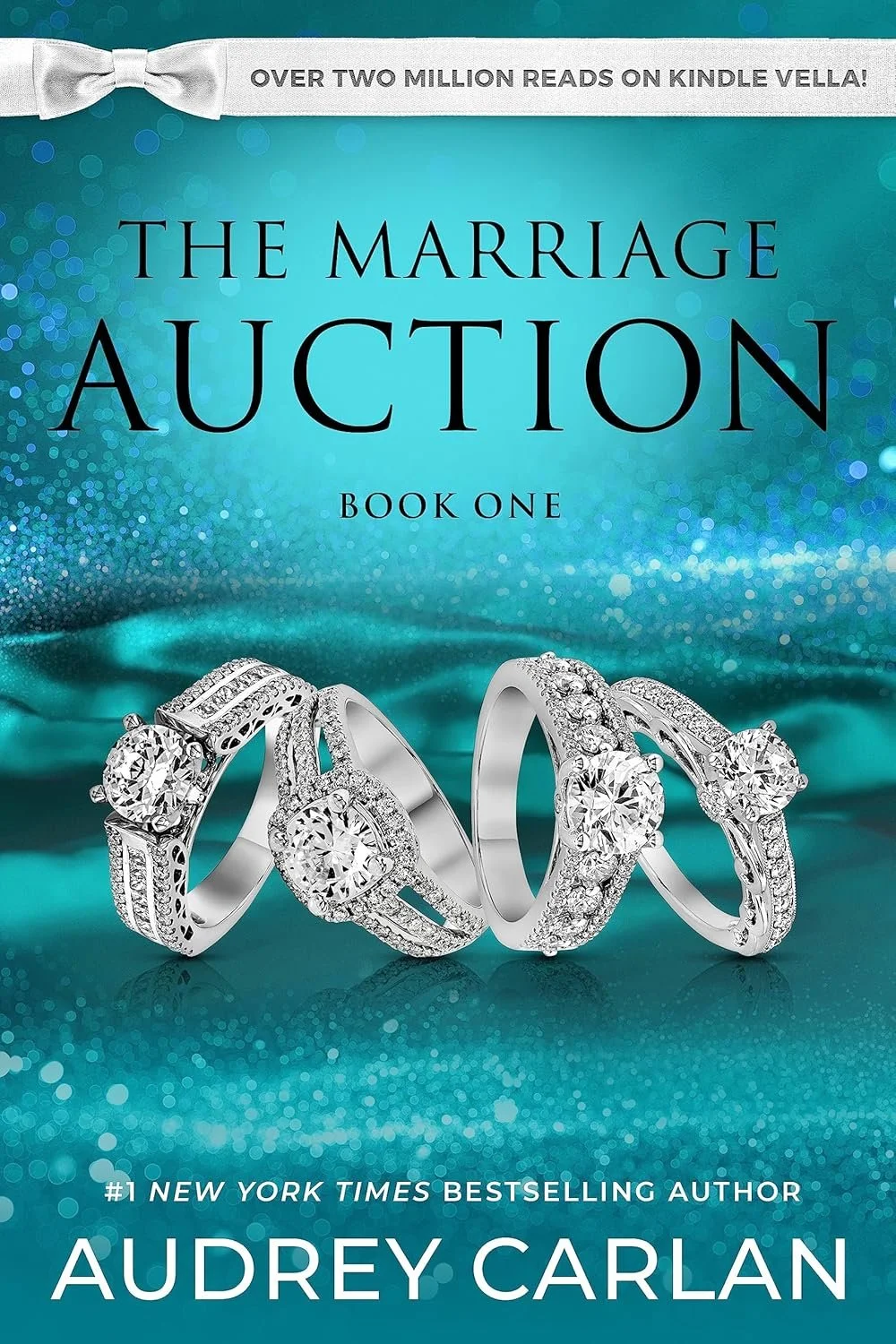 The cover of a book titled 'The Marriage Auction: Book One' by Audrey Carlan, featuring four diamond rings on a blue sparkly background. A white banner at the top states 'Over two million reads on Kindle Vella!'