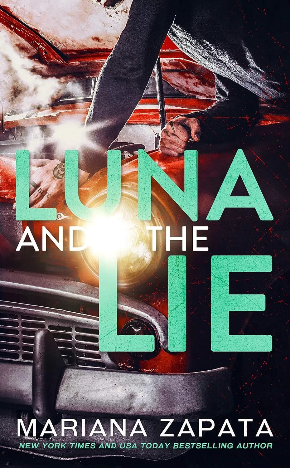 Book cover of "Luna and the Lie" by Mariana Zapata. The cover shows a person working on a red vintage car, with the focus on the car's front and the person's hand, which has rings and a tattoo. The title is displayed in large green and white text.