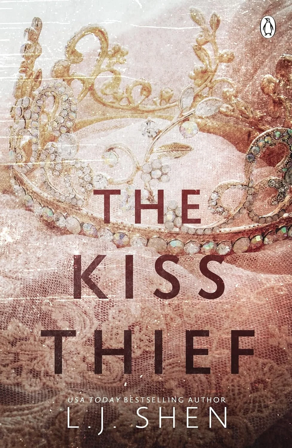 Book cover of "The Kiss Thief" by L. J. Shen featuring a pink background with a lace fabric and a diamond tiara.