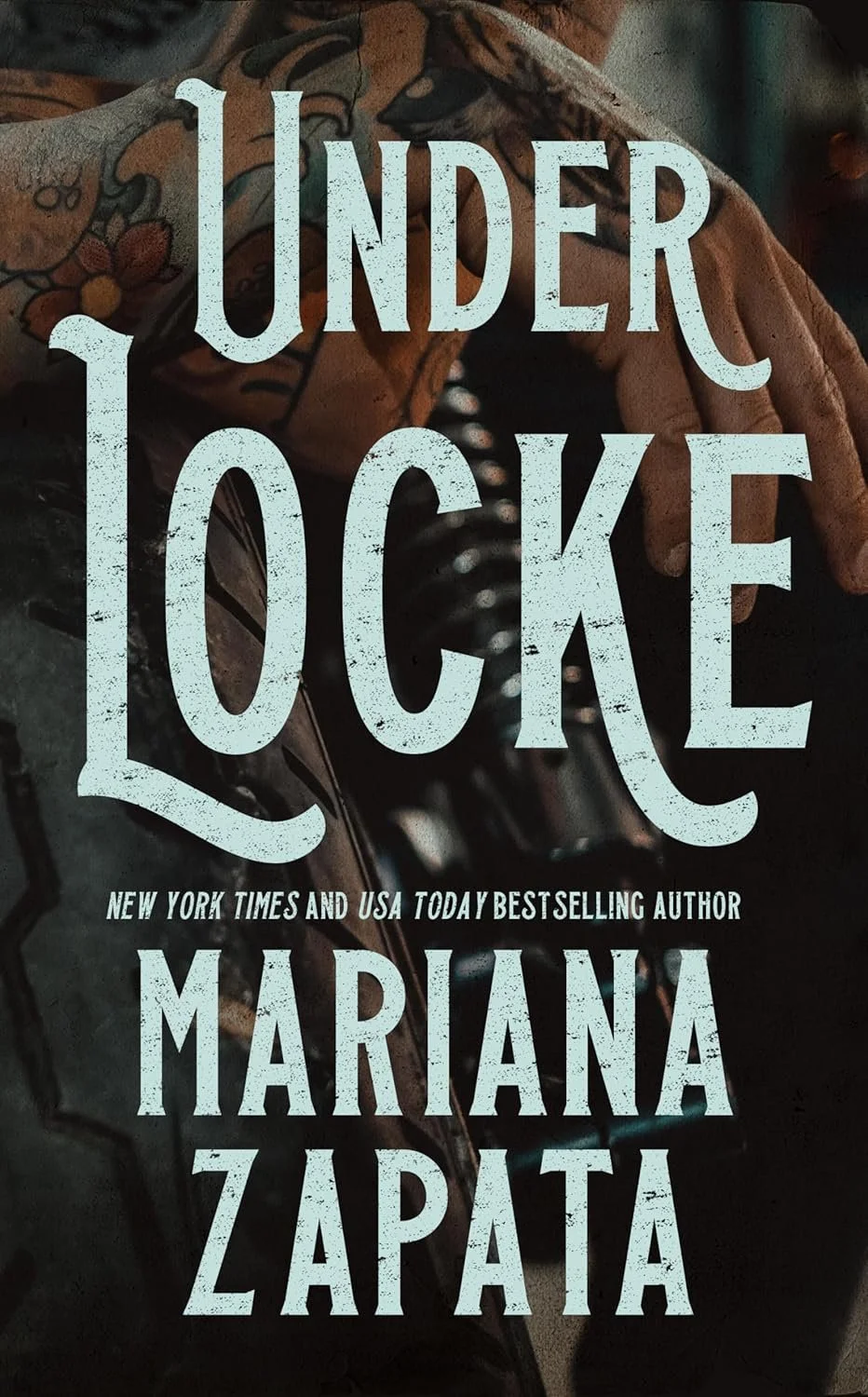 Book cover for "Under Locke" by Mariana Zapata, with large distressed blue text and a background featuring a leather glove, a metal object, and a floral-patterned cloth.
