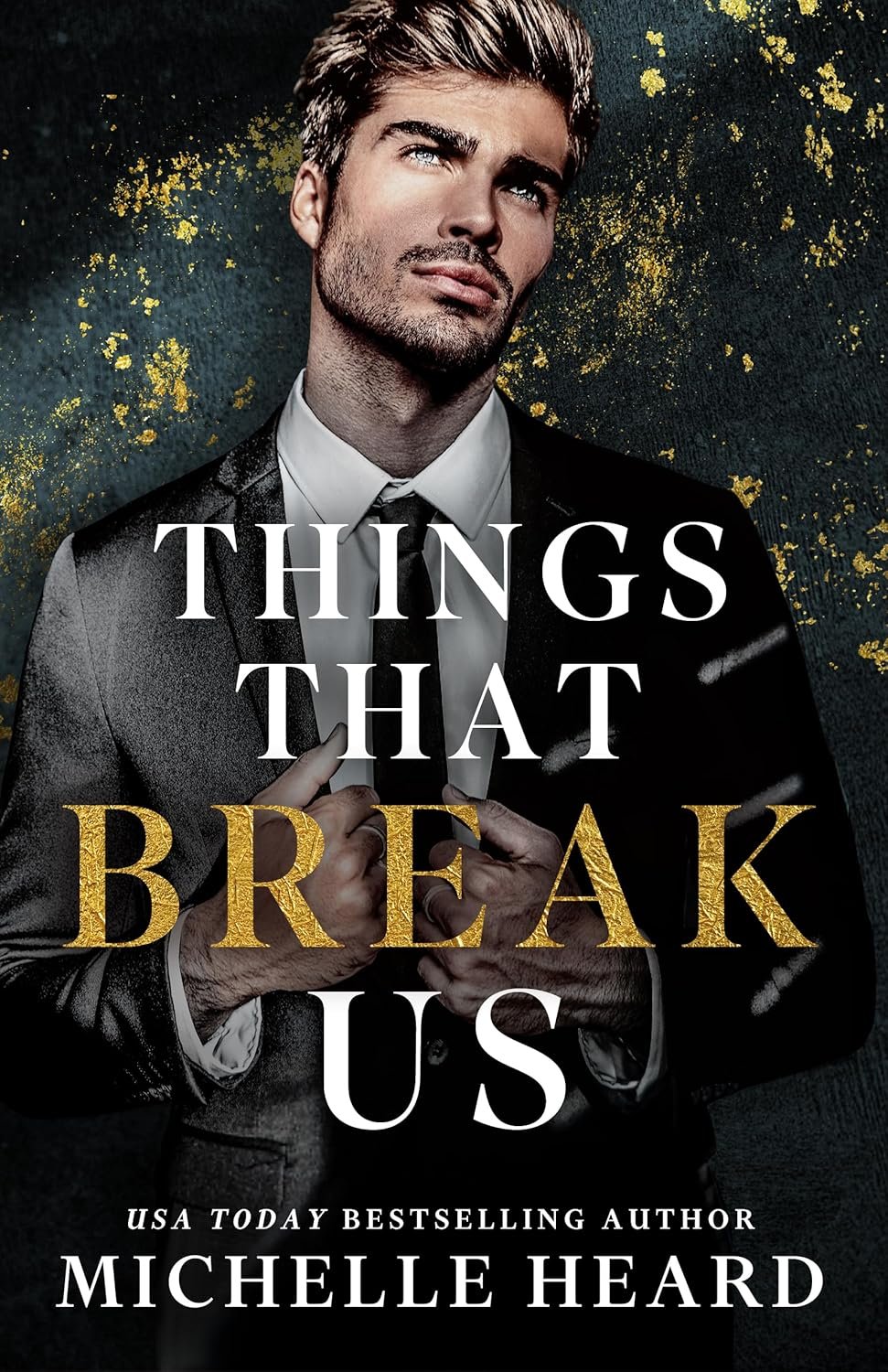 Book cover featuring a man in a suit adjusting his tie with gold speckles on a dark background. The title 'Things That Break Us' is prominent, with the author's name Michelle Heard at the bottom.
