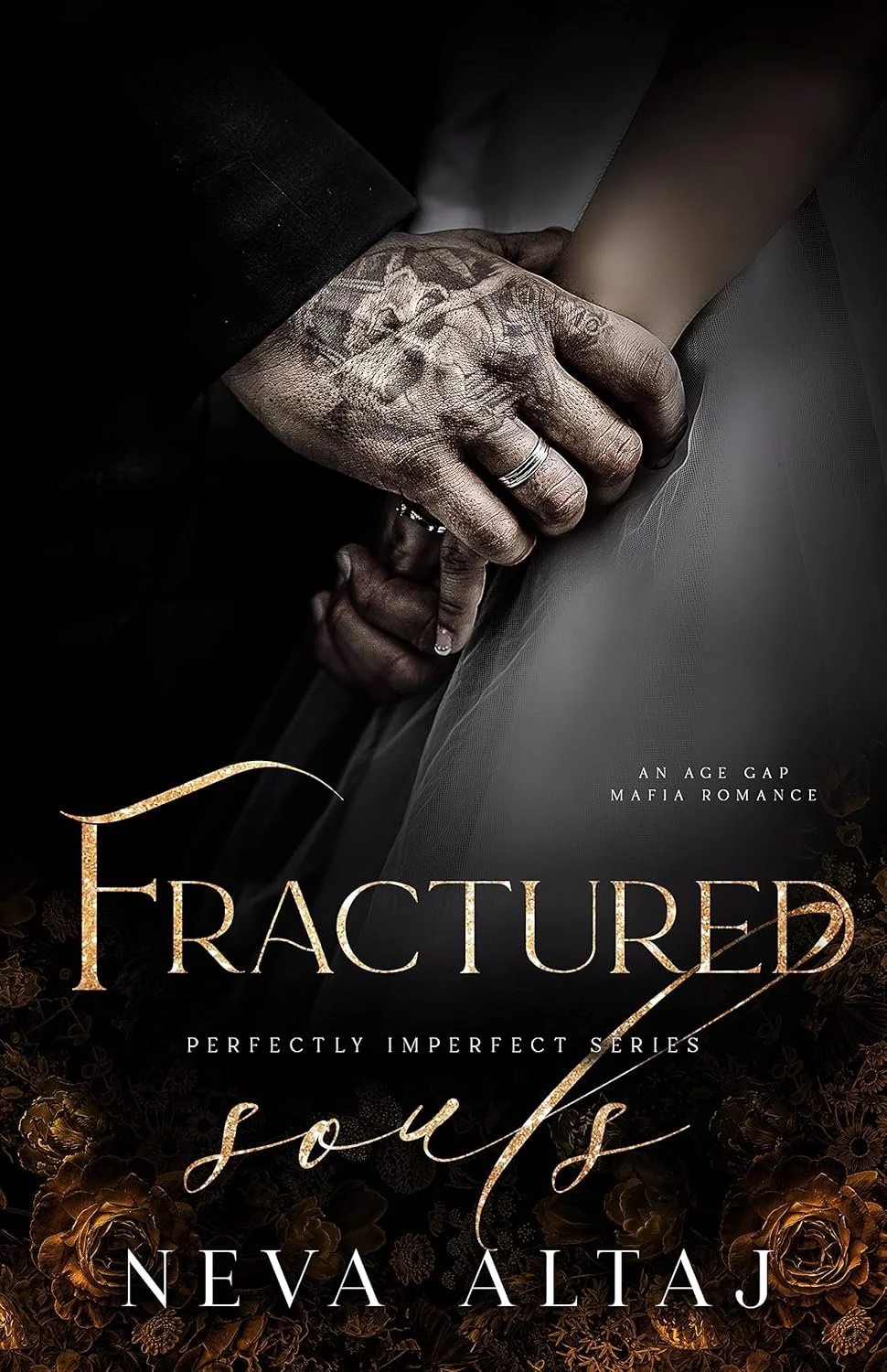 Close-up of a hand with tattoos holding another person's hand, both in dark clothing. The background is dark with gold rose patterns at the bottom. The title reads 'Fractured Souls' and the subtitle 'A Perfectly Imperfect Series,' written by Neva Altaj. Additional text includes 'An Age Gap Mafia Romance.'