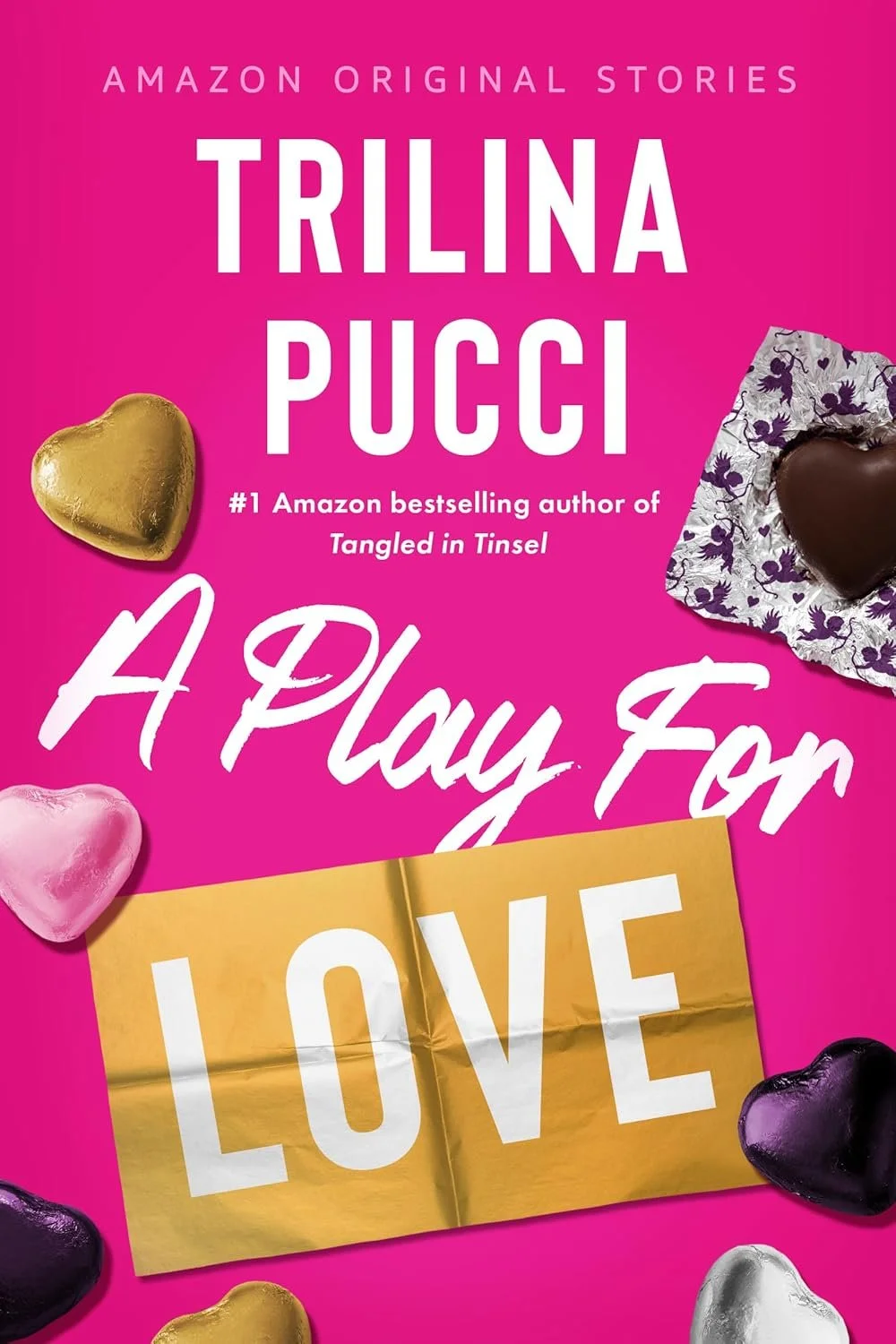 Book cover of 'A Play for Love' by Trilina Pucci, featuring pink background and heart-shaped chocolates in gold, pink, purple, black, silver, and white, with text advertising Amazon original stories.