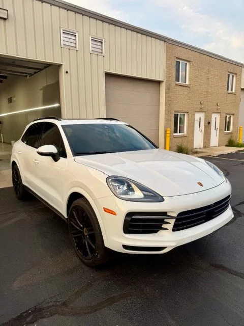 A white Porsche SUV parked outside at PrimeVue Protection in Plainfield, IL