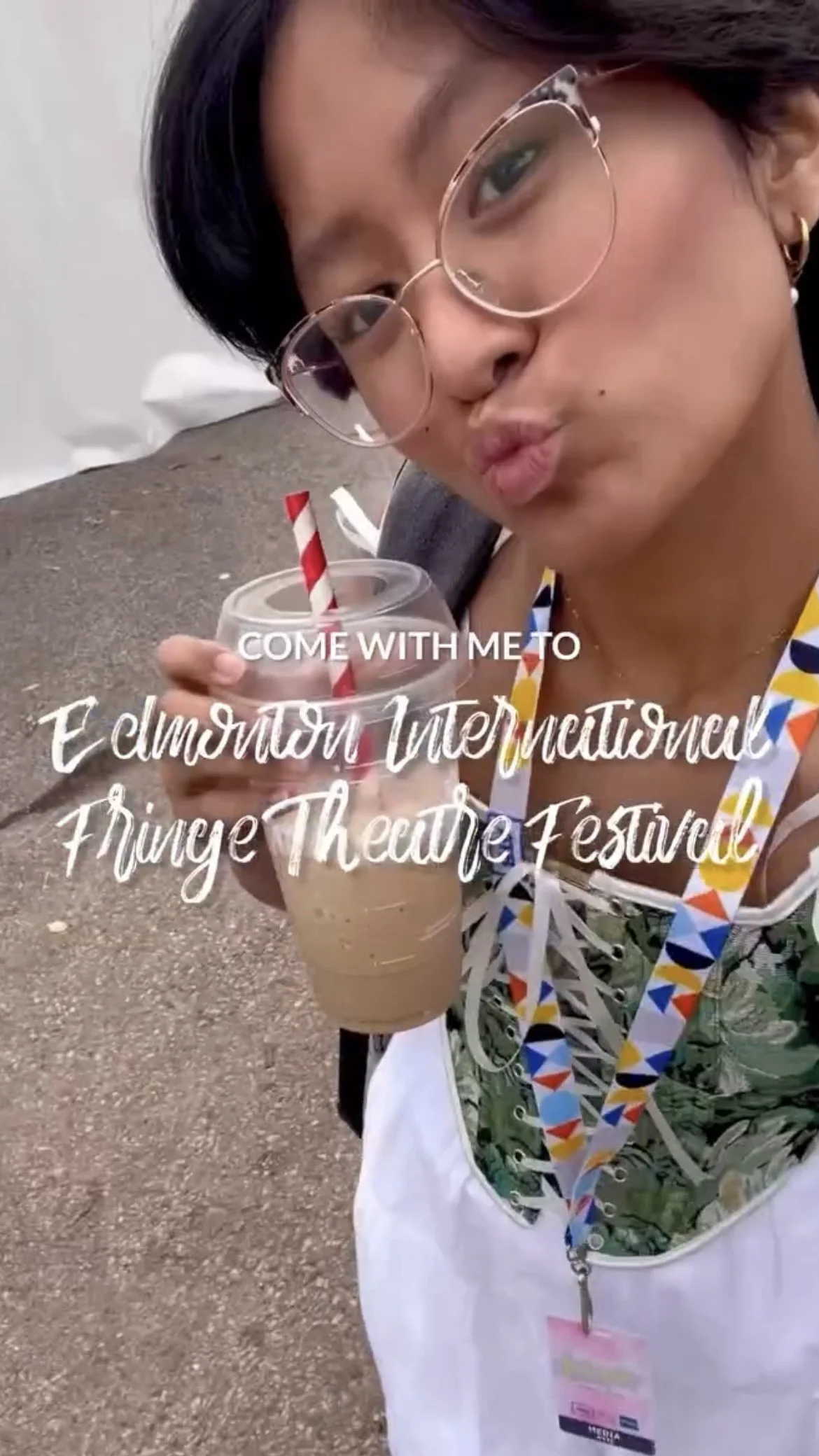 Young Filipino woman holding a drink with an overlaying text that says, "Come with me to Edmonton International Fringe Theatre Festival."
