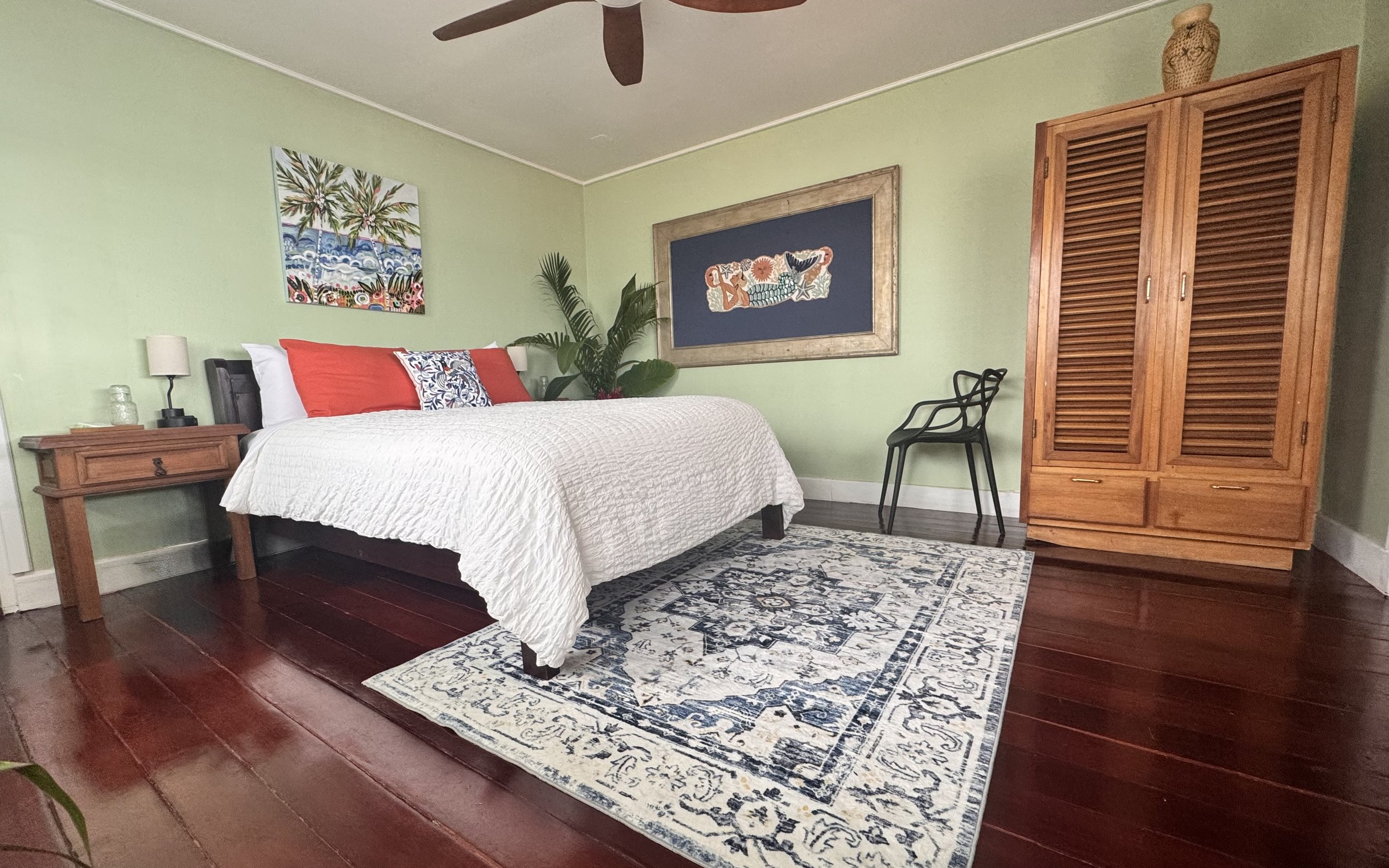 Queen guest bedroom at The Jungle Hotel in Bocas Del Toro with air conditioning, tropical decor and hardware floors.