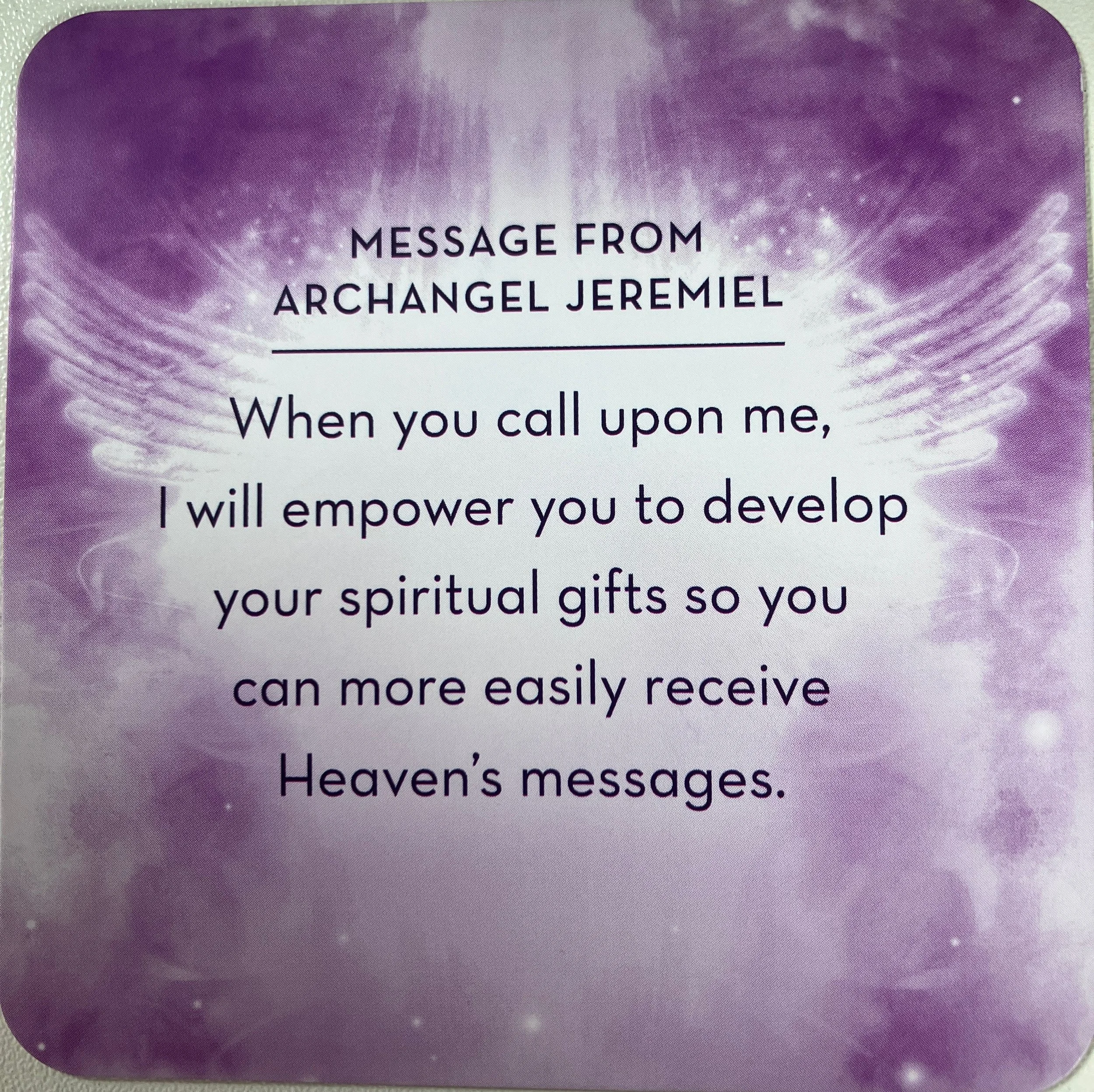 A spiritual message card with a purple background and white light effects, featuring a quote from Archangel Jeramel about spiritual empowerment and receiving messages from Heaven.