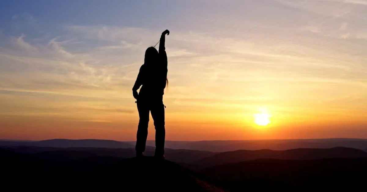 Woman dancing on a mountain at sunset.jpg