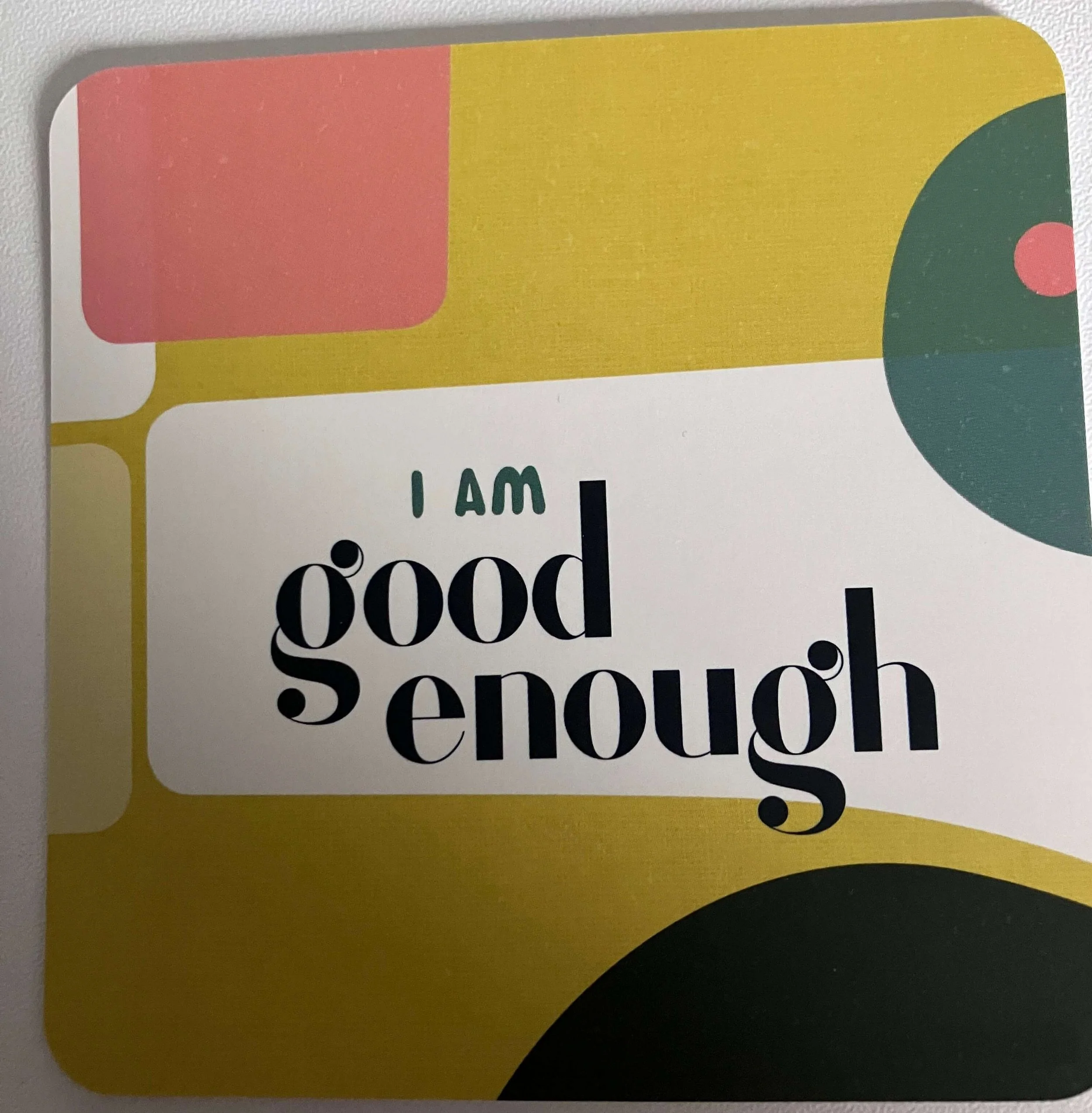 Colorful geometric background with the message 'I am good enough' in black and green text.