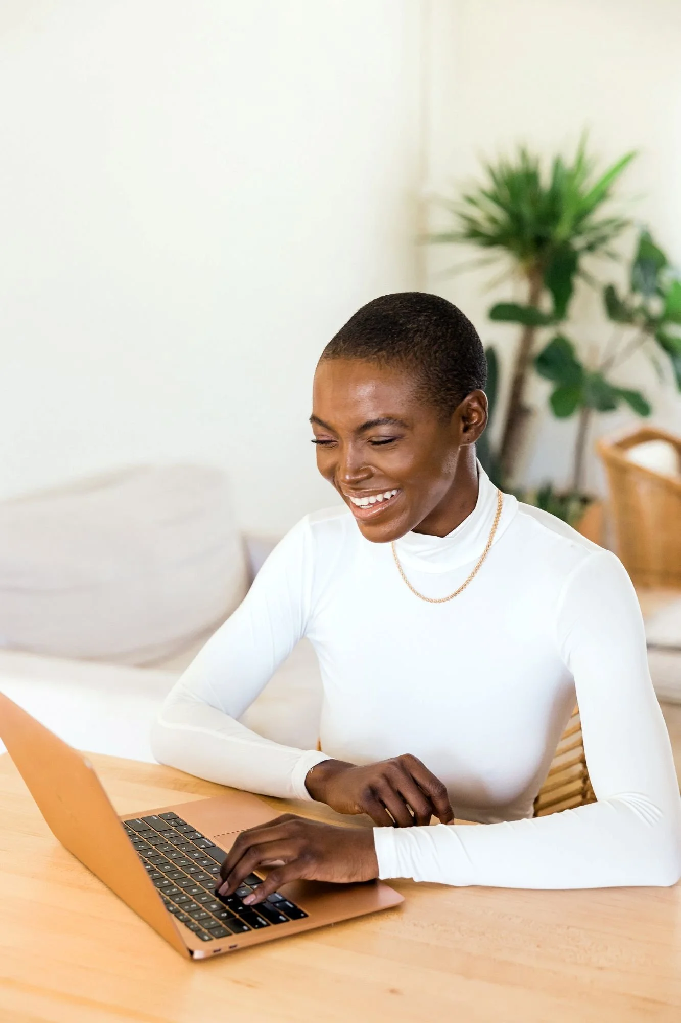 A happy woman smiling at her laptop