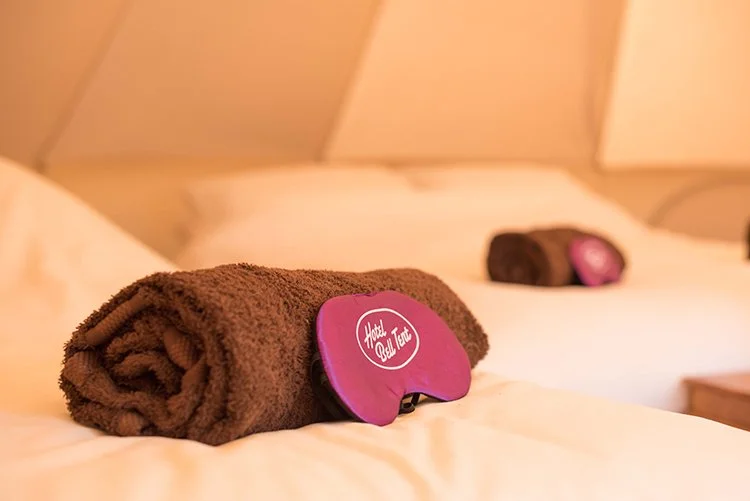 Boutique glamping tent, with bedding, towels, and eye masks