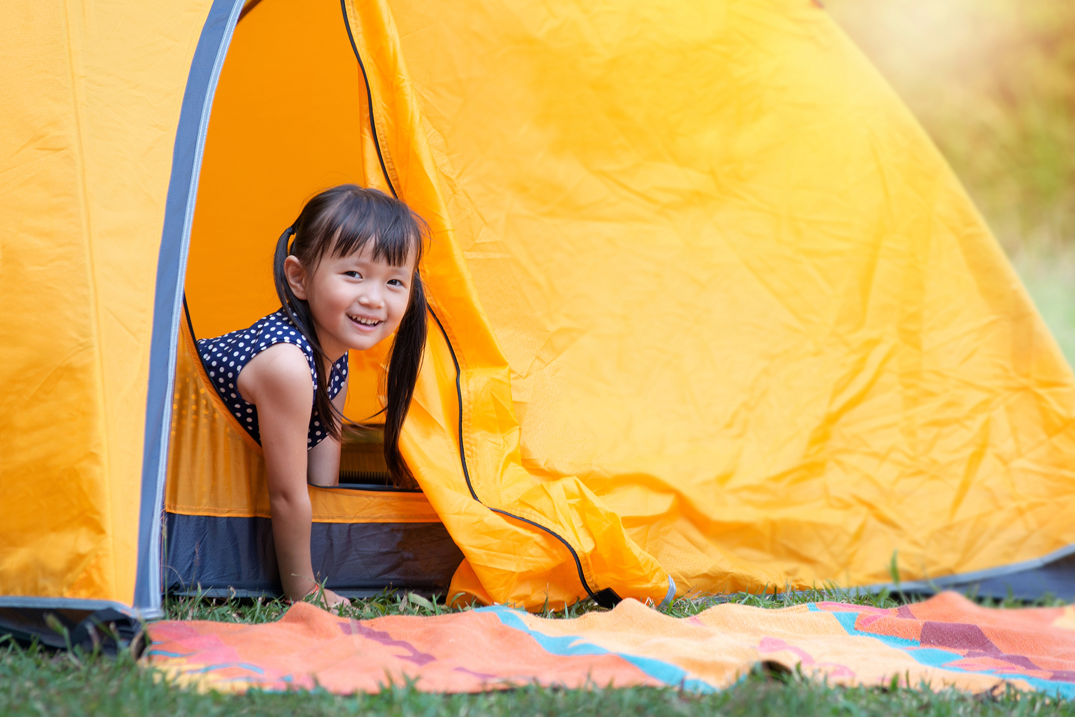 Young girl in tent at glamping music festival