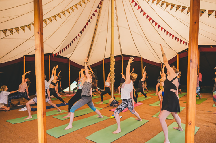 Morning yoga class at boutique glamping site