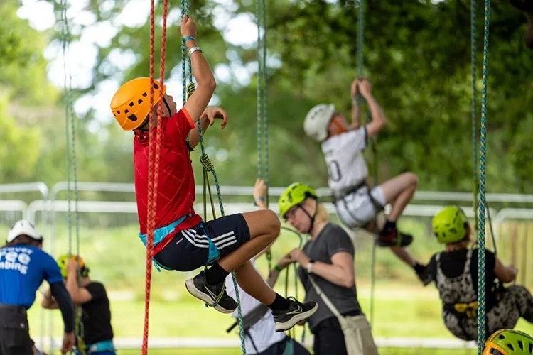 Children enjoying outdoor adventure activities near luxury glamping and boutique camping event site