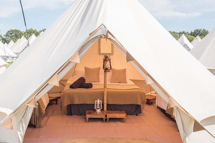 Cosy Deluxe bell tent interior at boutique glamping campsite