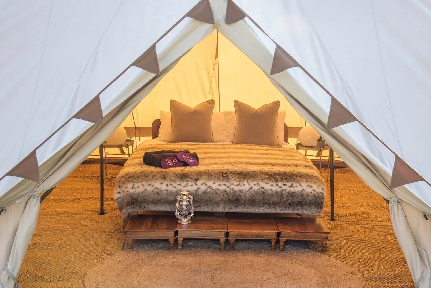 Inside view of a luxury, furnished glamping bell tent at festival