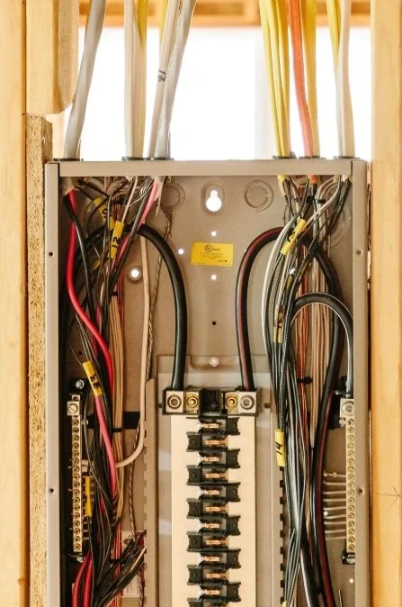 Electrical breaker panel with various wires connected.