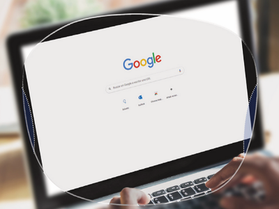 A person browsing Google search on a laptop.