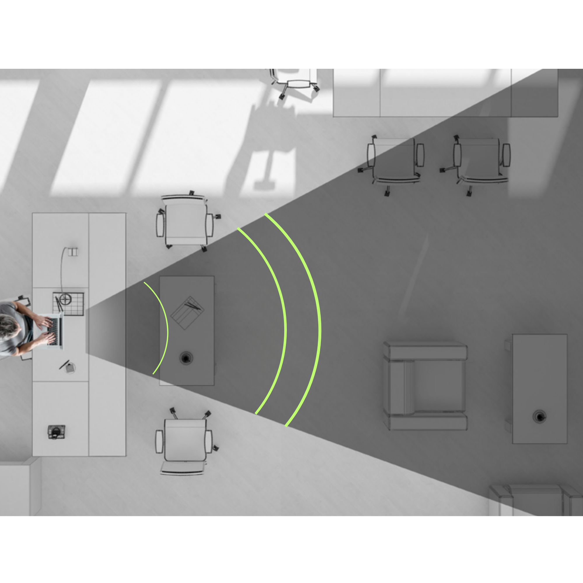 An overhead view of a person using a laptop at a desk, with a spotlight effect projected forward, illuminating a workspace with chairs, tables, and office equipment.