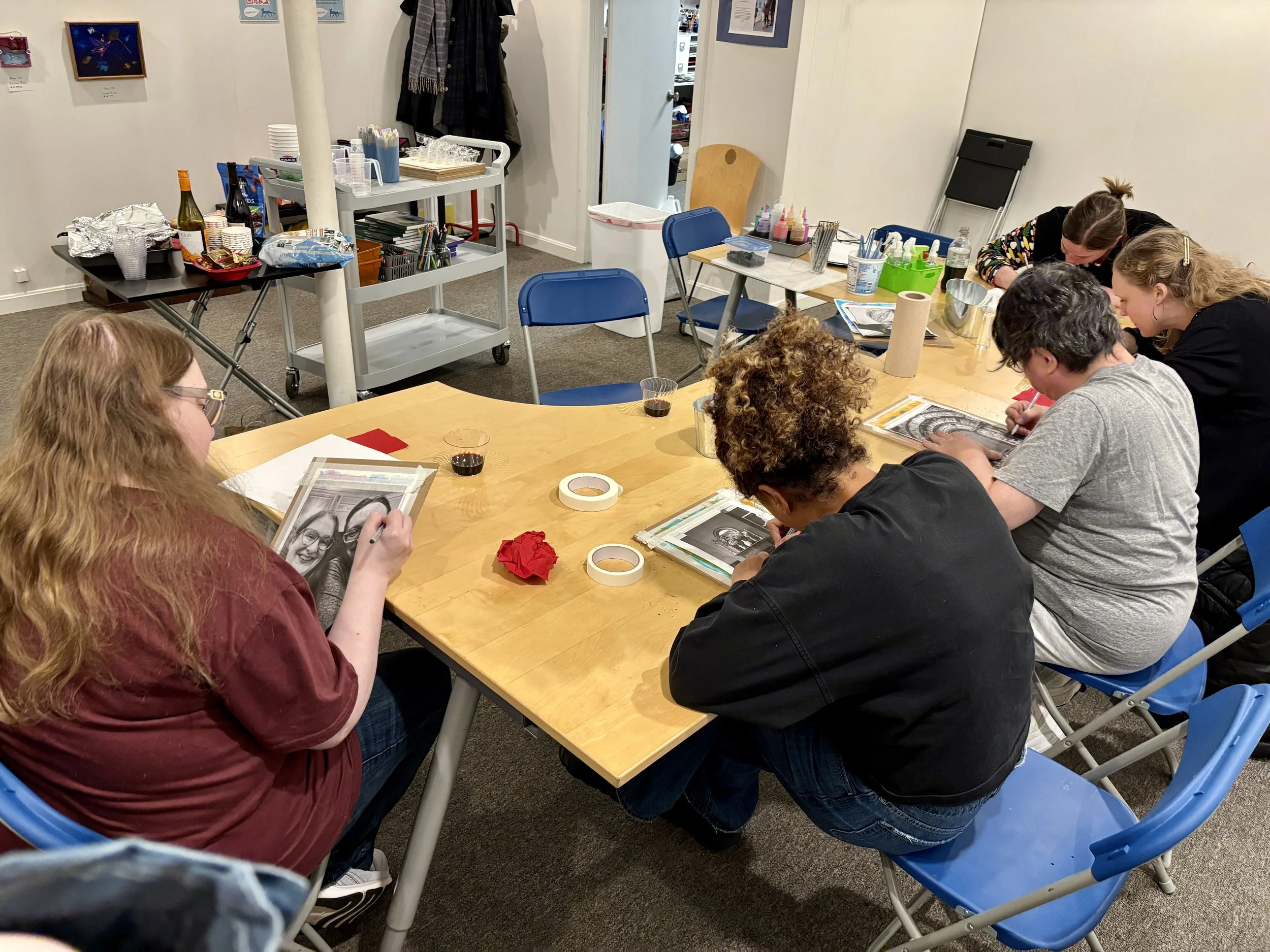 A group of adults creating art at Blue Mouse Gallery