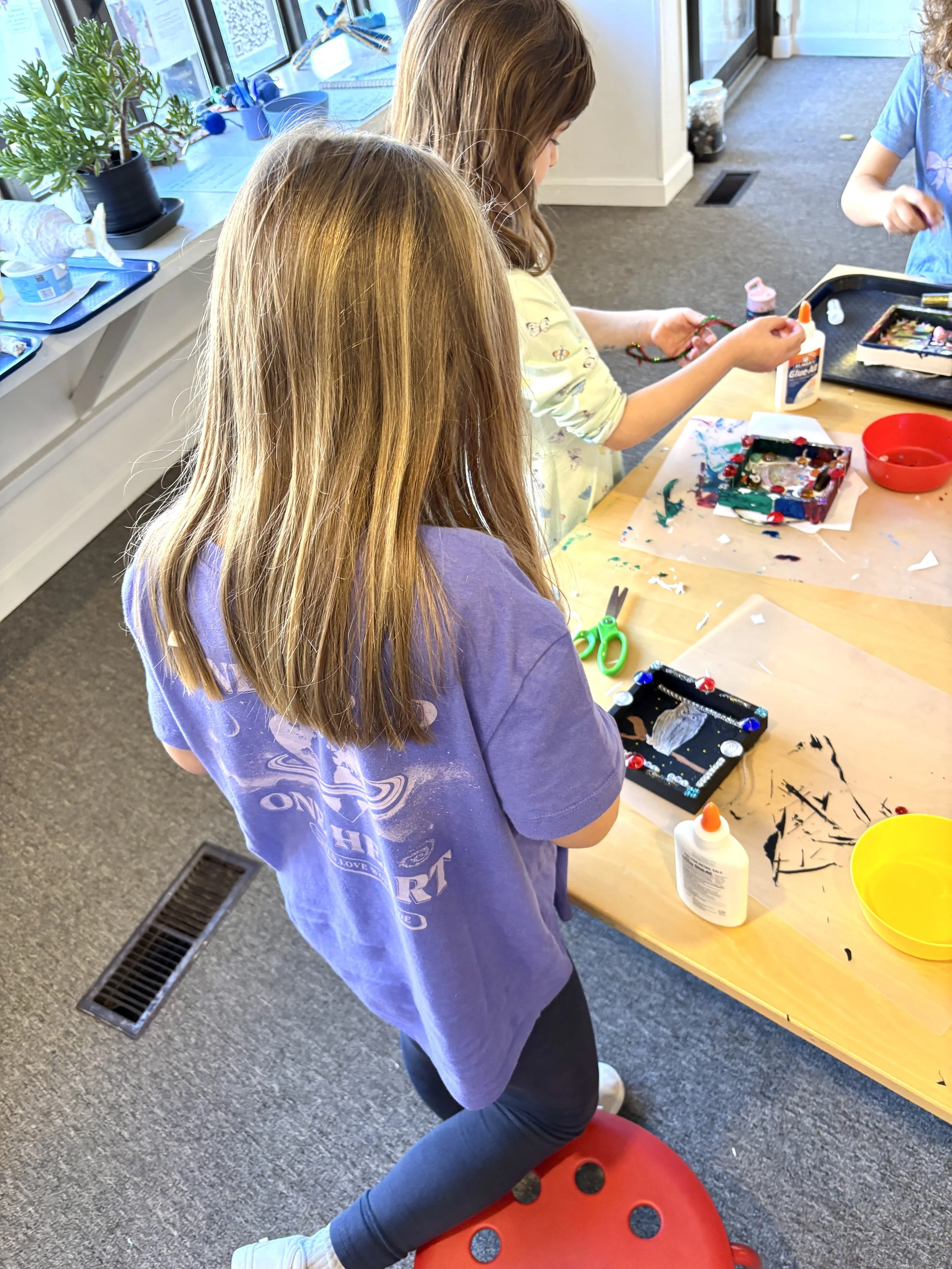 Children working on an art project at Blue Mouse Gallery