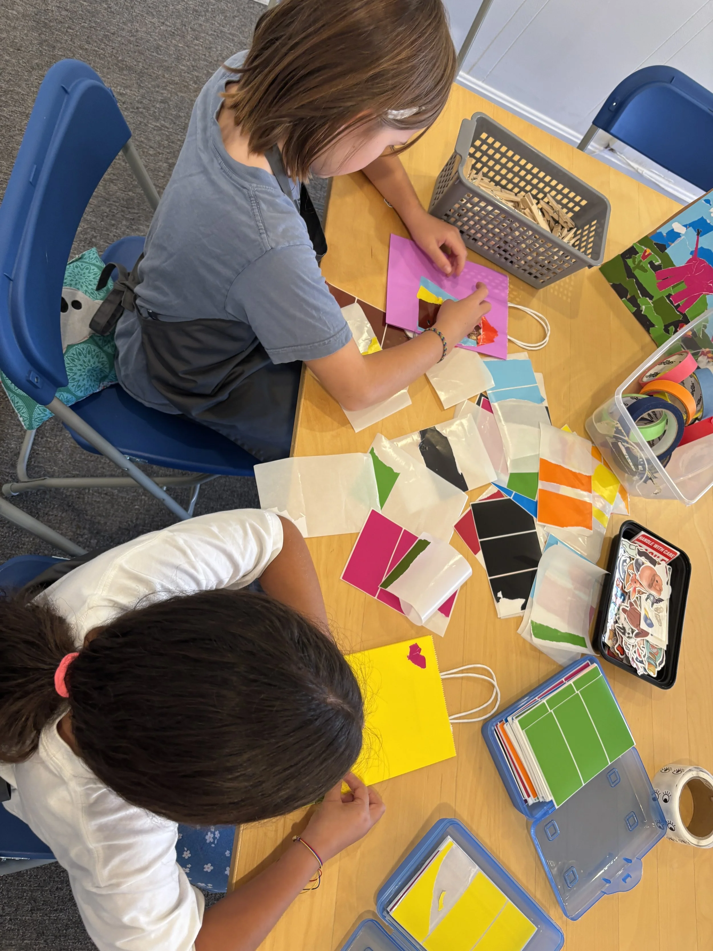 Two children doing colorful crafts during a birthday party