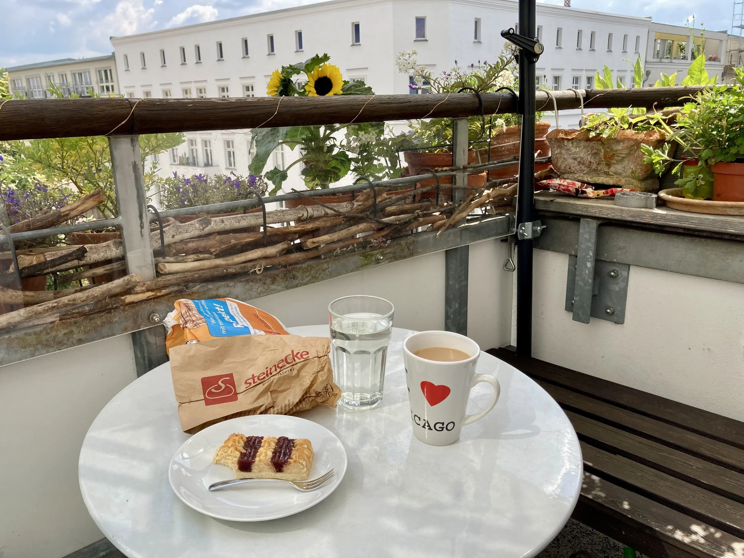 A table on a balcony in Berlin with typical German coffee and cake