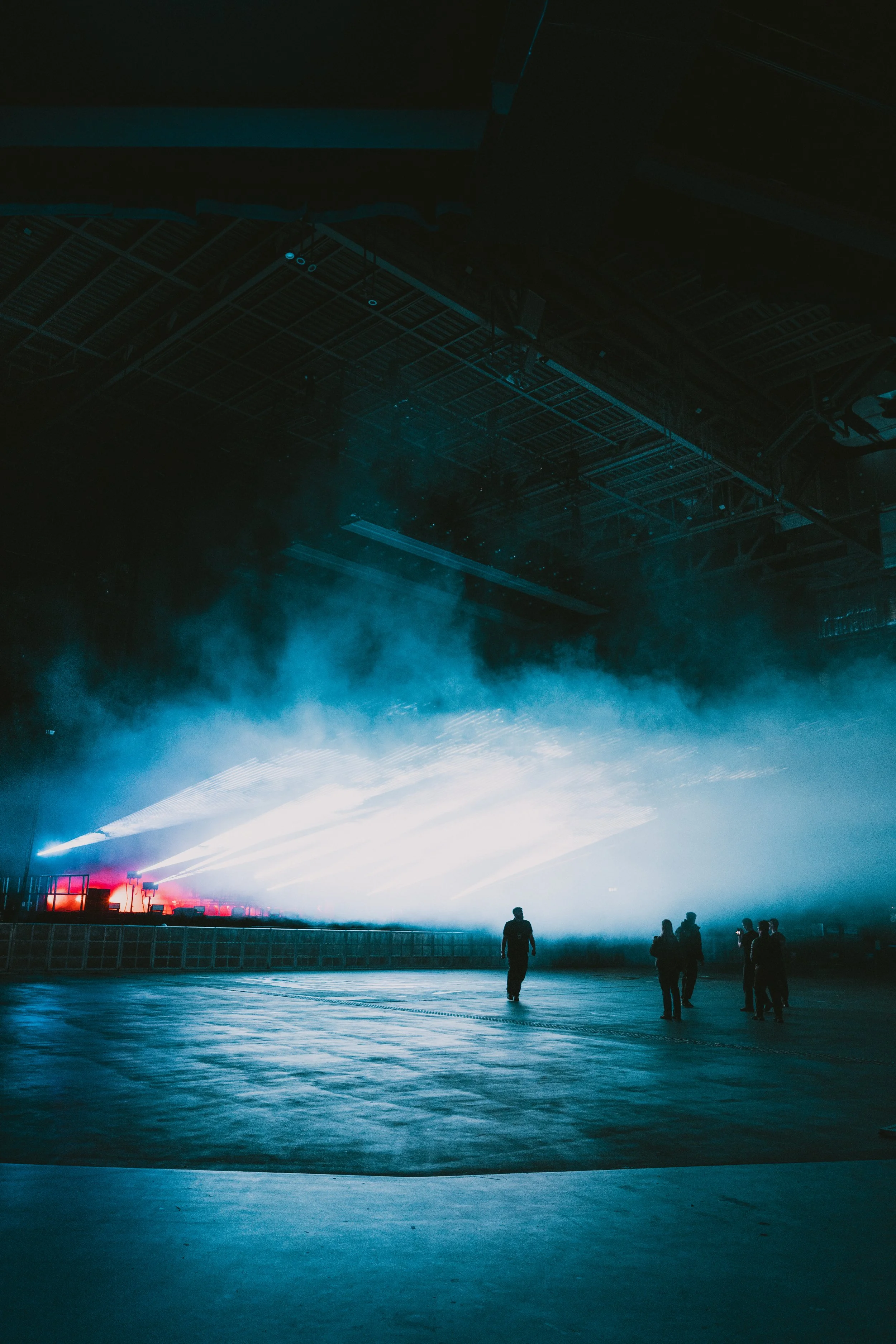 Empty arena before doors with stage lighting and haze during setup, photography by BGL Media