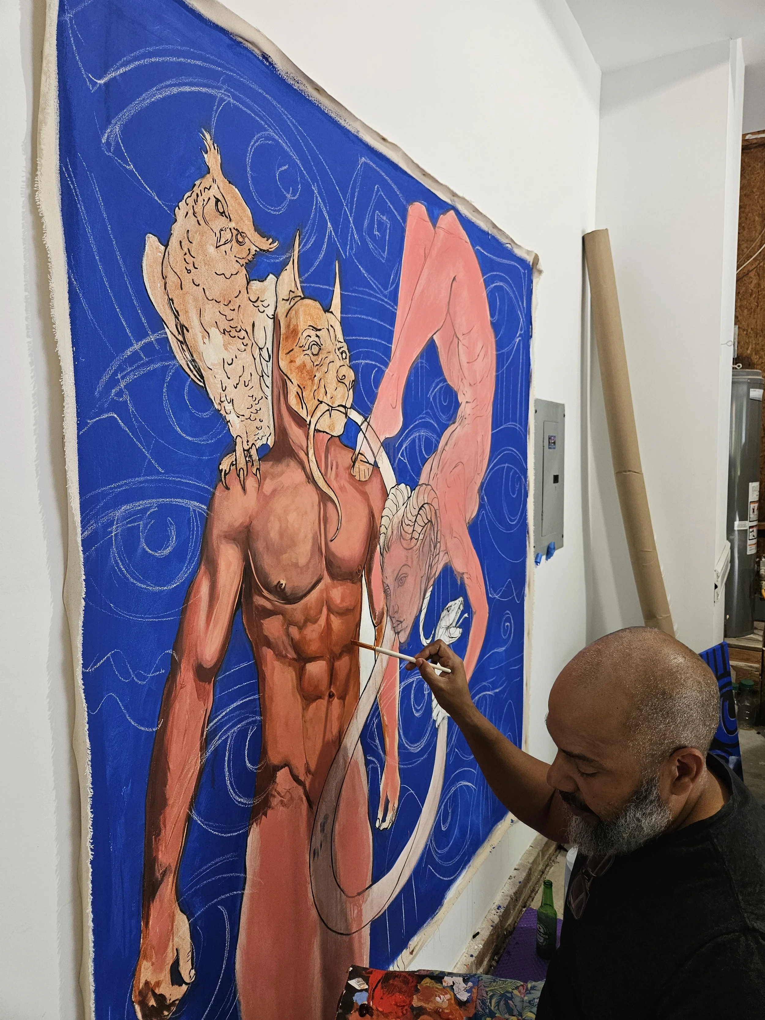 Edward Telleria painting the figures of Plenitude in his studio, early color stage